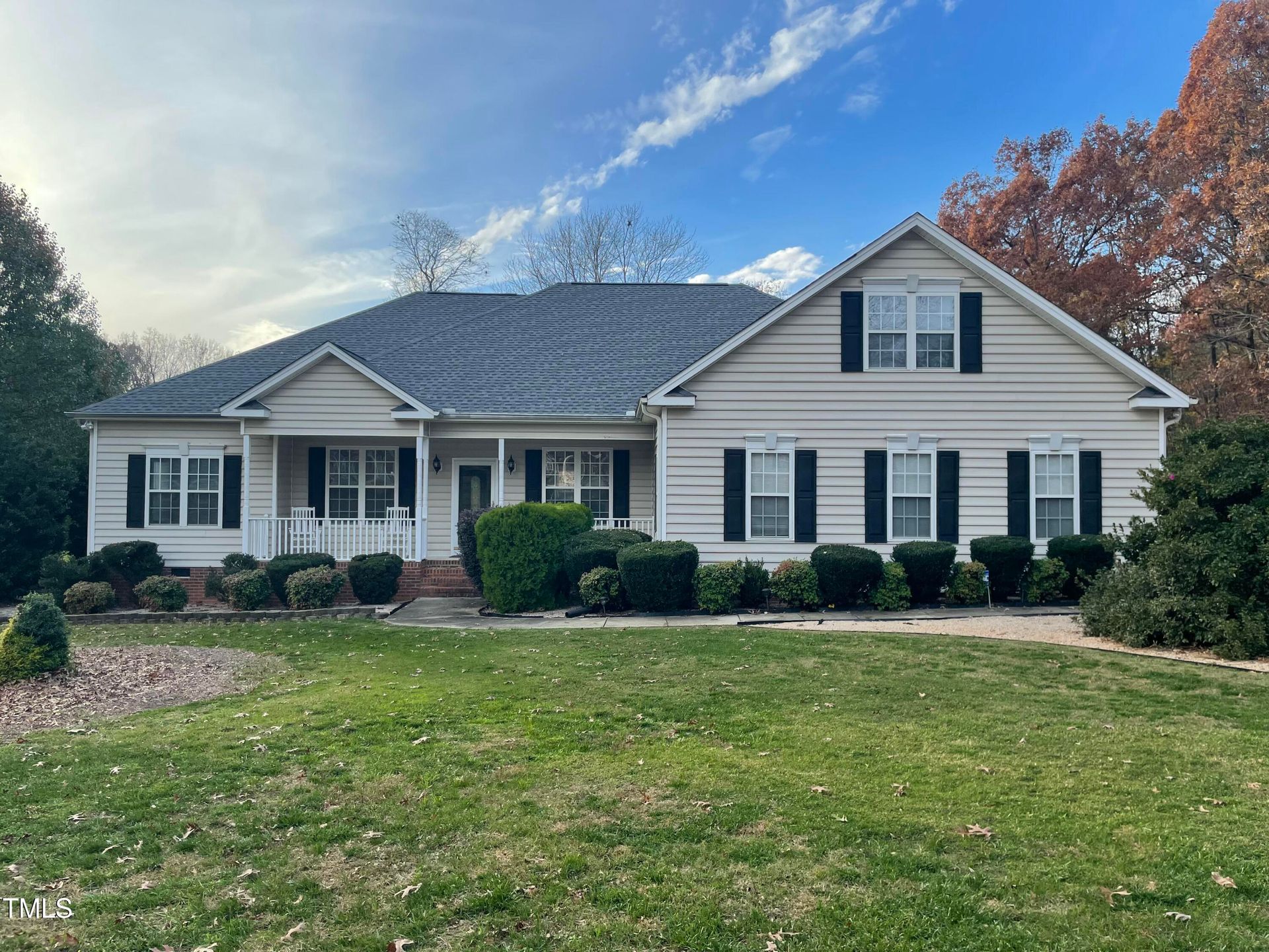 Large house with garage and tree