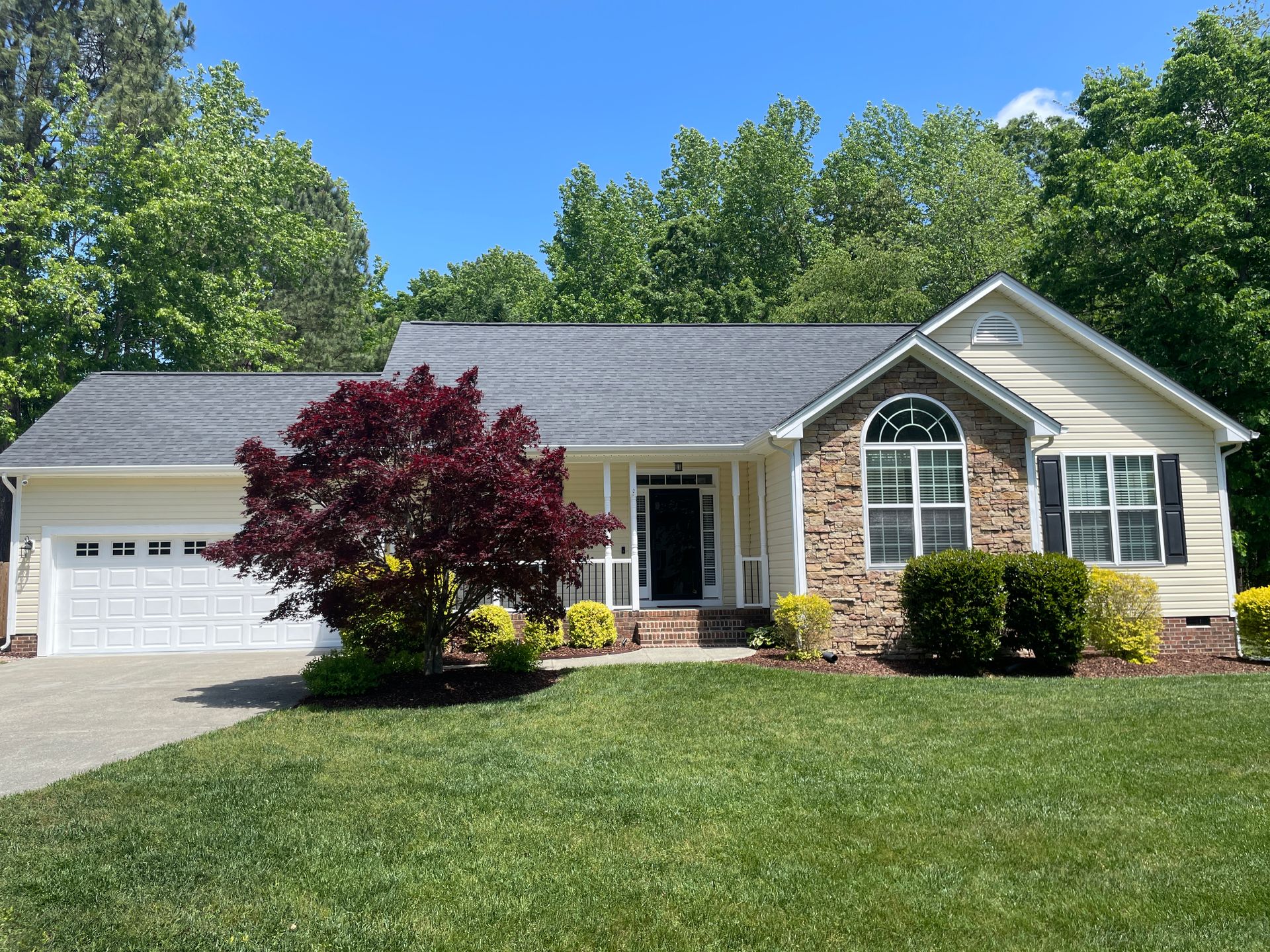 Large house with garage and tree
