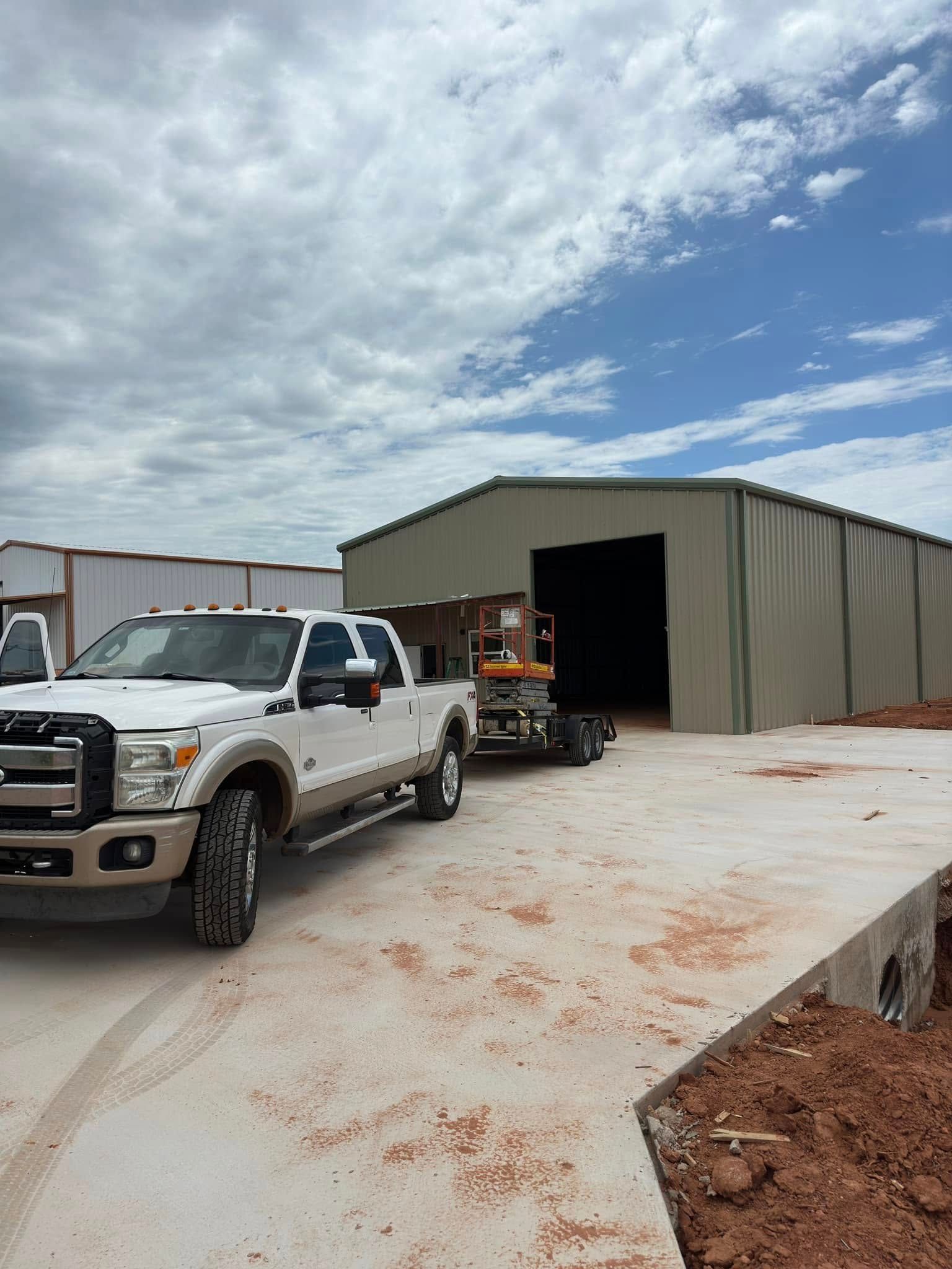 A white truck is parked in front of a building.