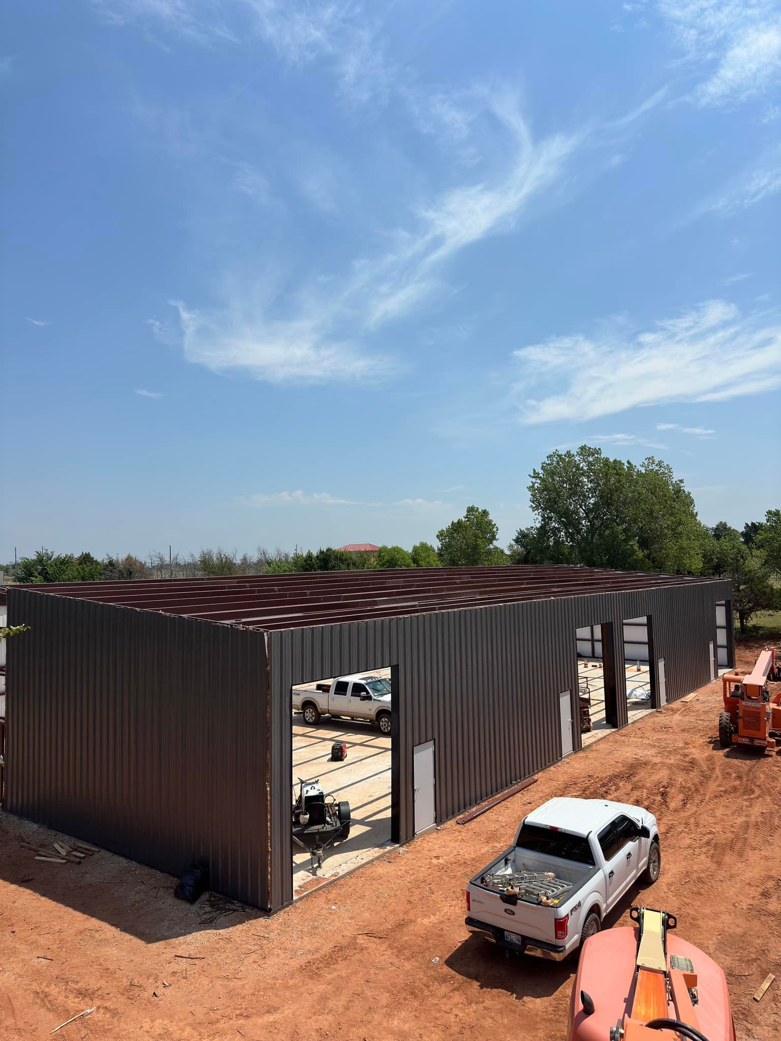 A truck is parked in front of a building under construction.