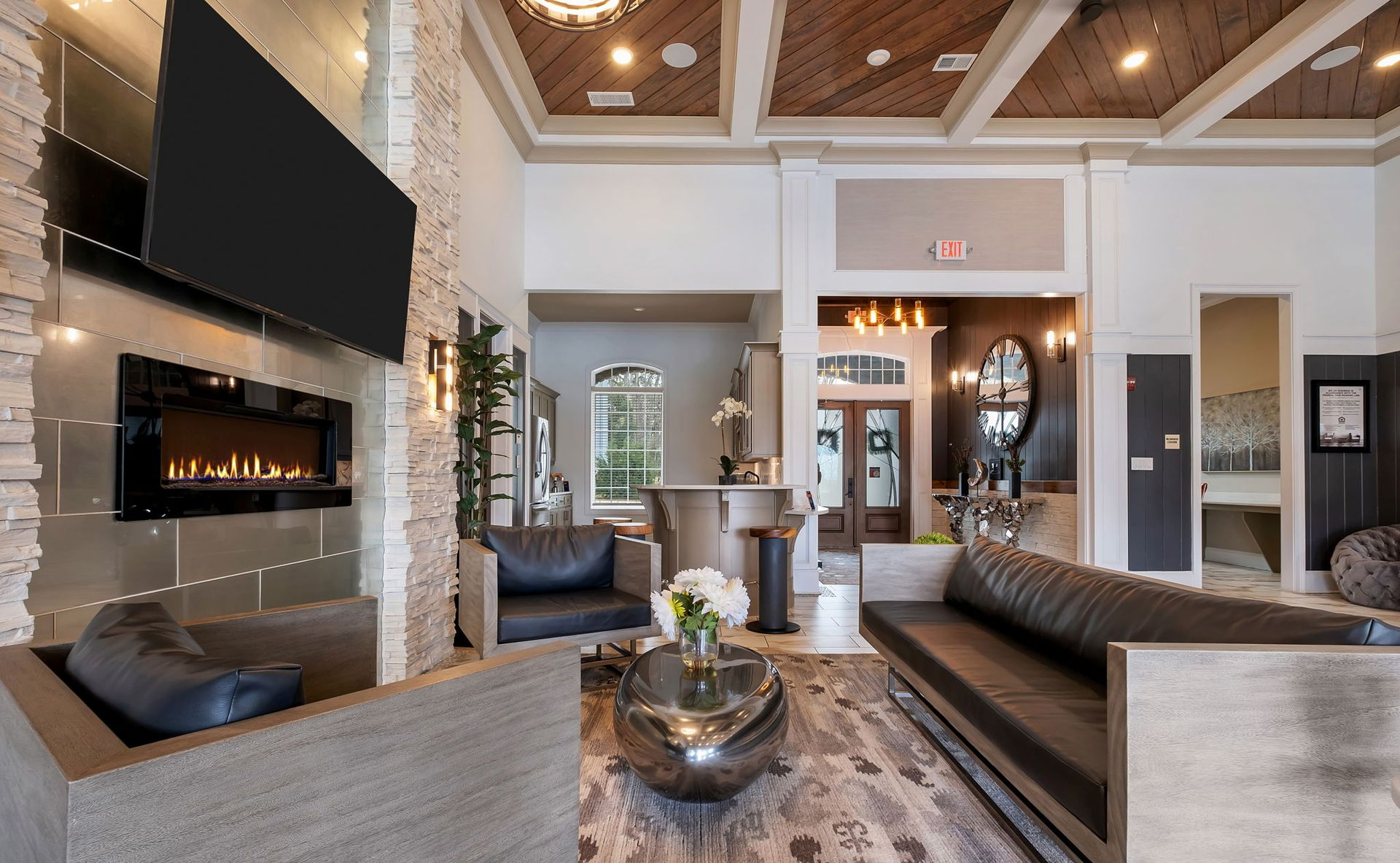 Modern community lounge area  with flat screen TV, fireplace and comfortable seating perfect for congregating.