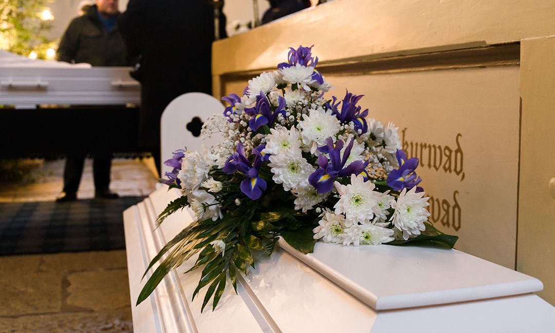 casket with a Boquete of flowers on top