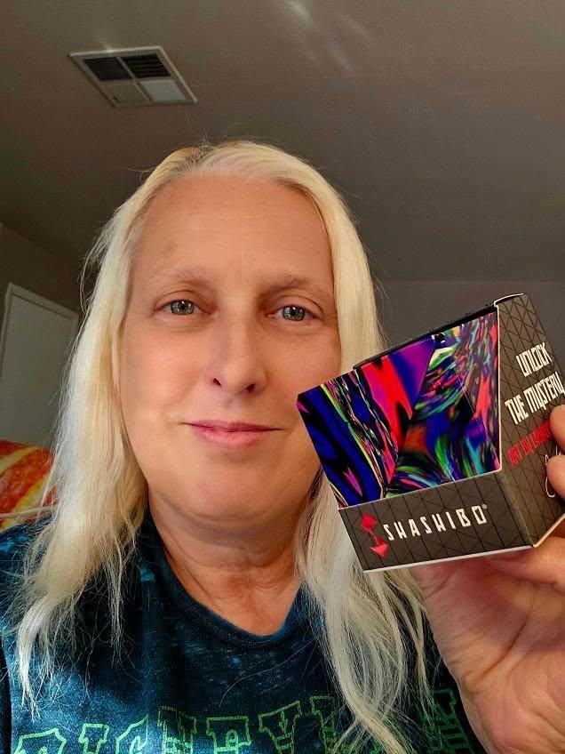 Jodi Jill, founder of International Puzzle Day holding a Laurence Gartel Shashibo Magnetic Puzzle Cube