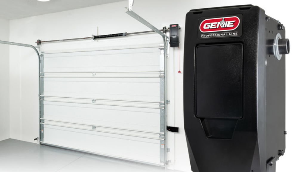 White garage door and black Genie opener on a white wall in a garage.