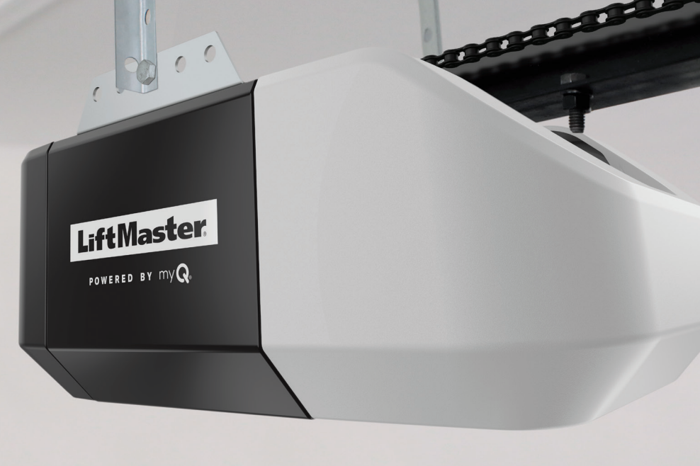 LiftMaster garage door opener, white and black, mounted on a garage ceiling.