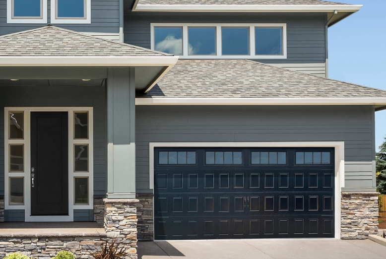 Gray house with a black garage door and front door.