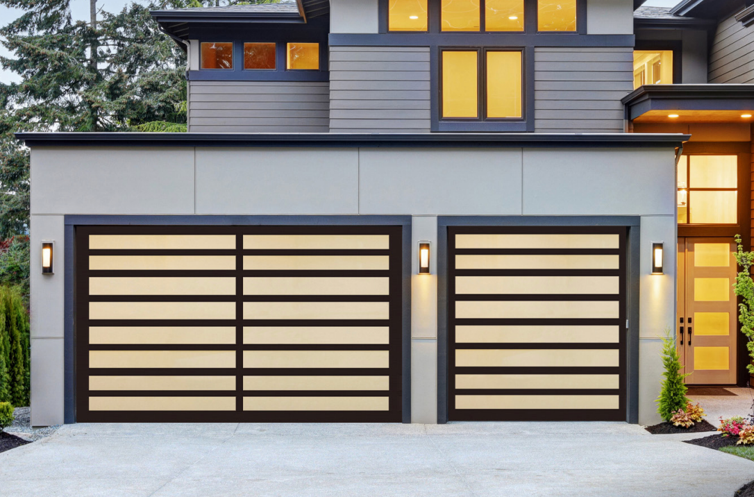 Modern home with two garage doors; tan horizontal panels, black frames; gray exterior.