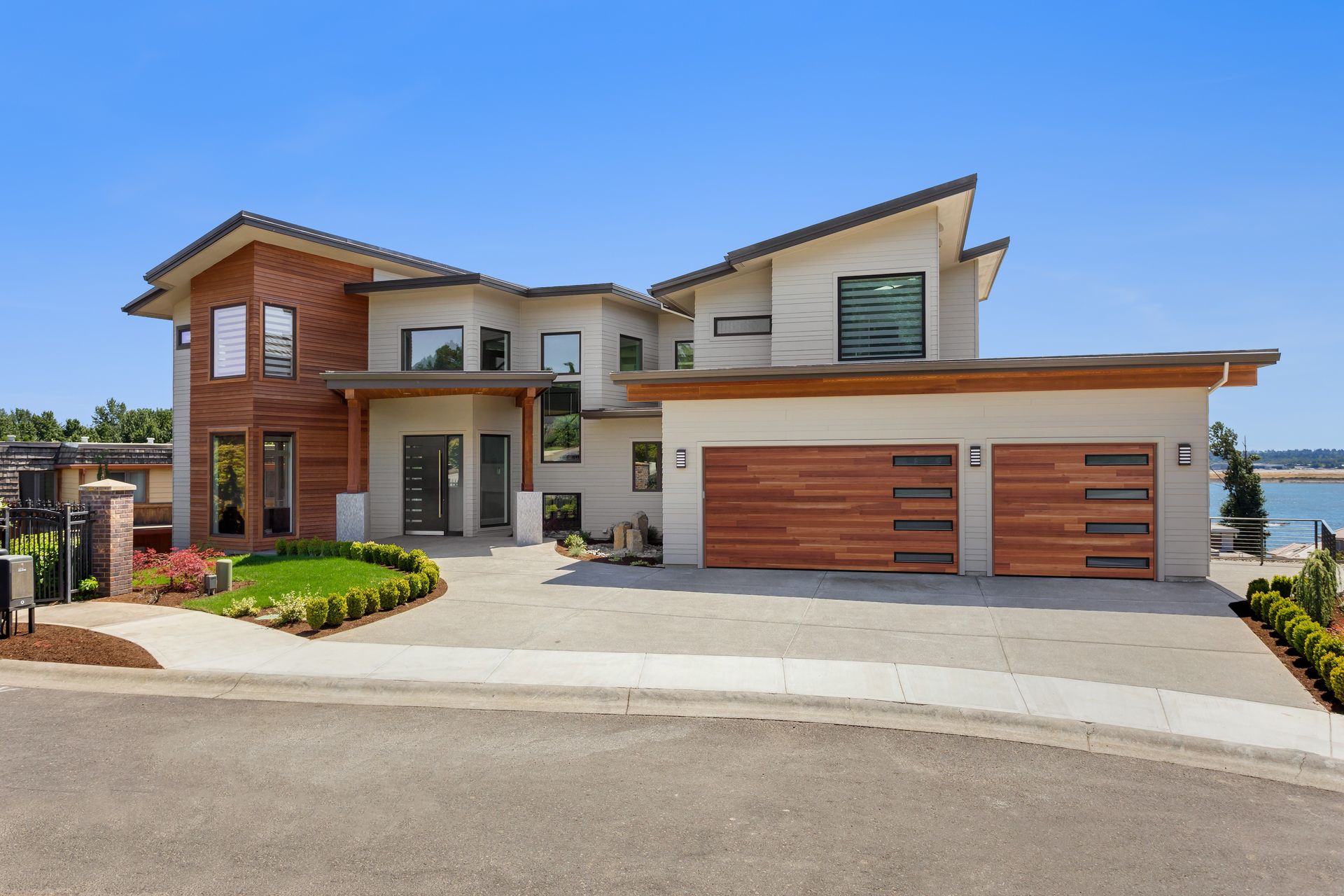 Dark blue house with brown garage door and front door; stone accents.