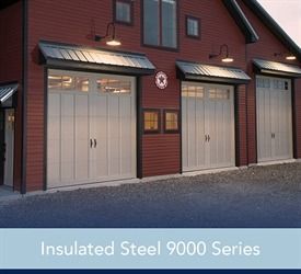 Black garage doors with crisscross design on beige house.