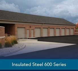 Black garage doors with crisscross design on beige house.