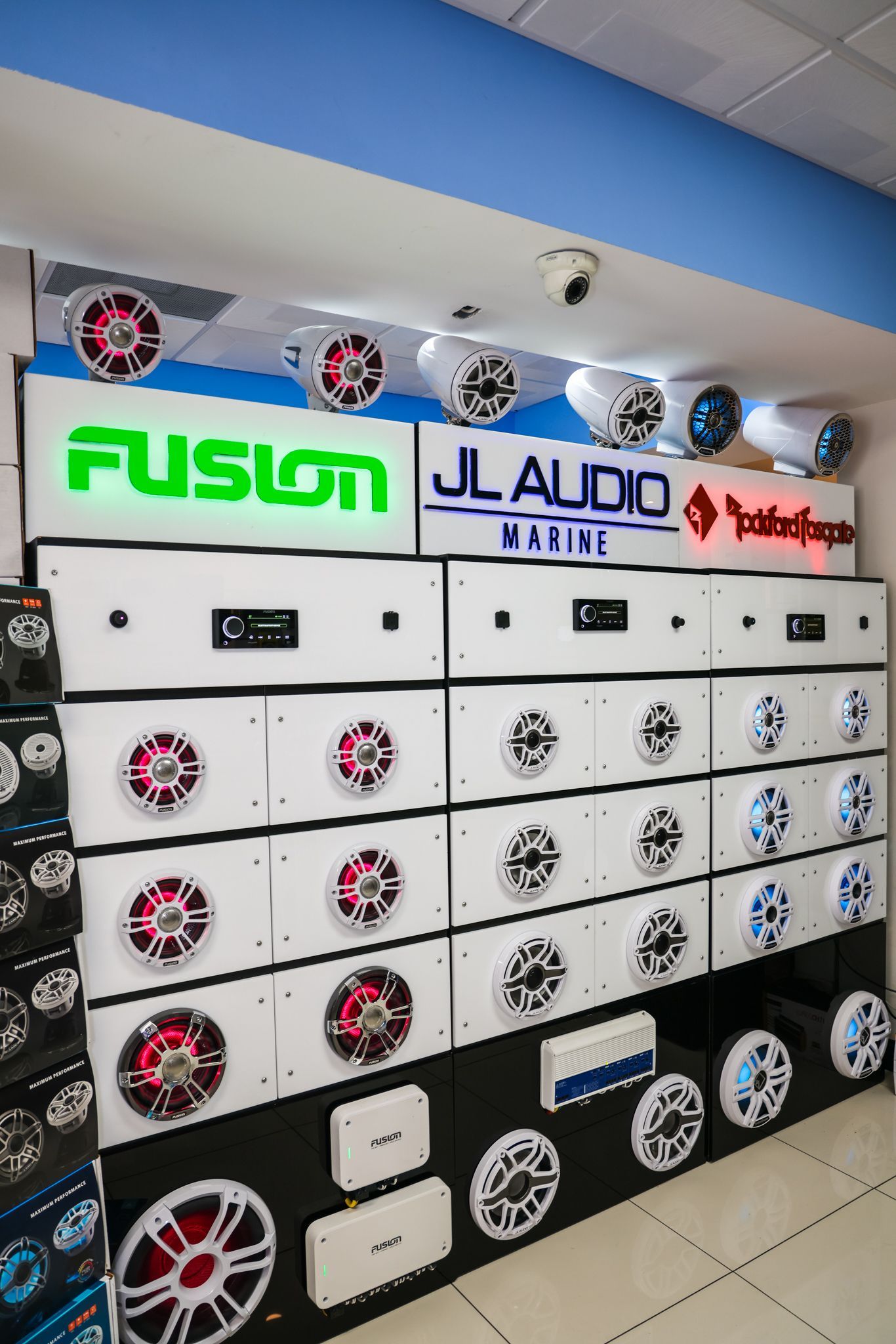 A store filled with lots of speakers and a sign that says fusion jl audio.