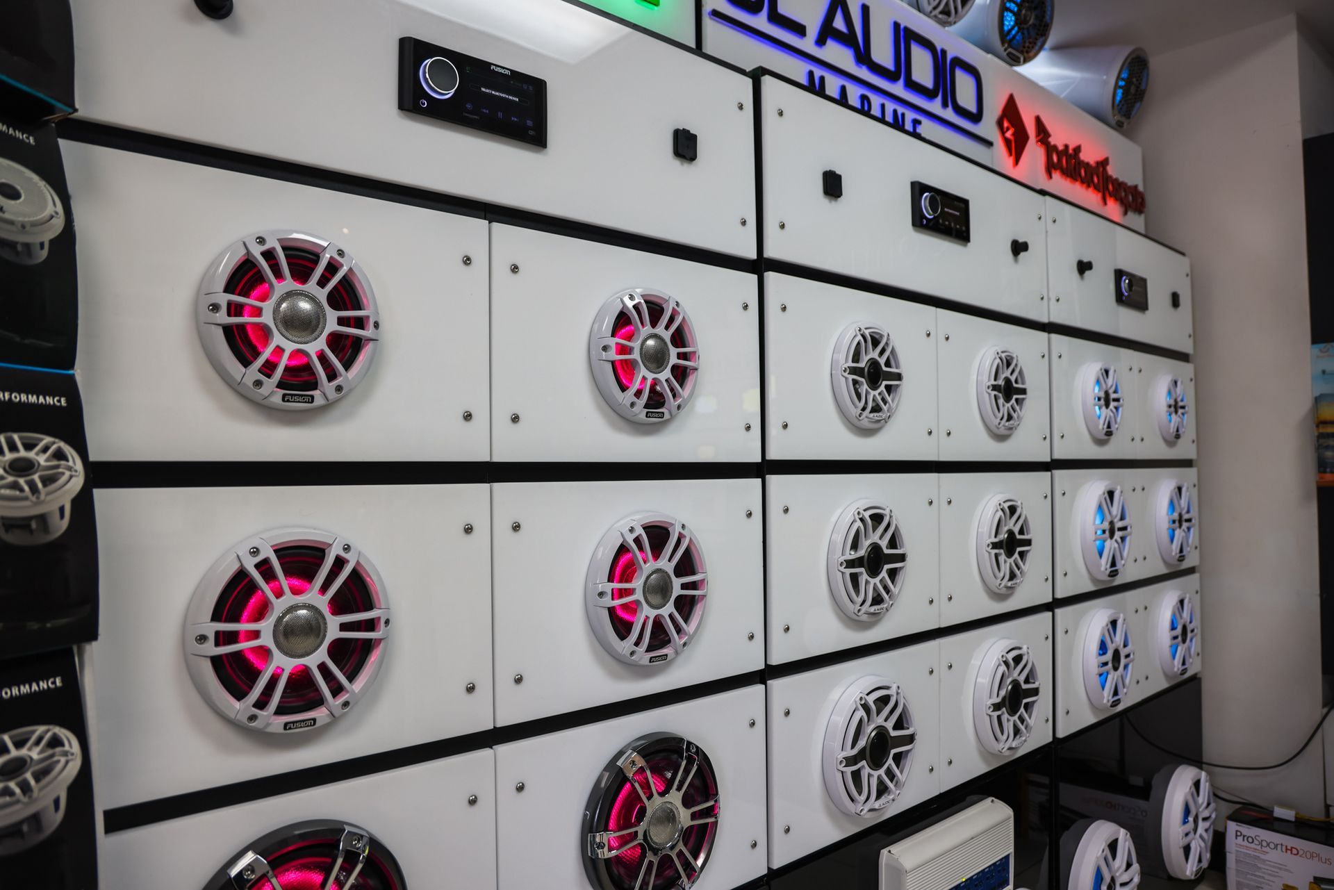 A wall filled with lots of speakers in a store.