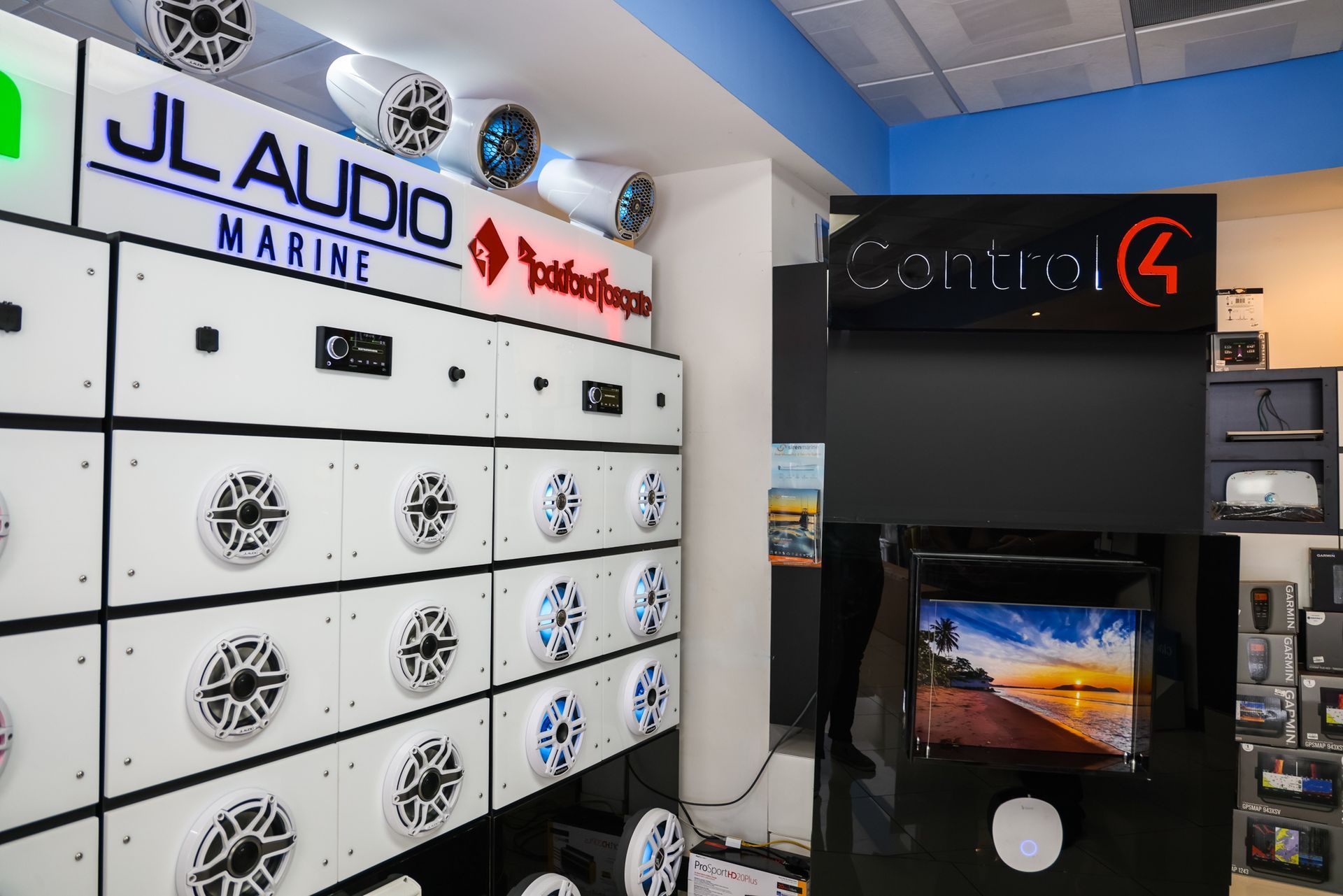 A room with a lot of speakers and a tv on the wall.