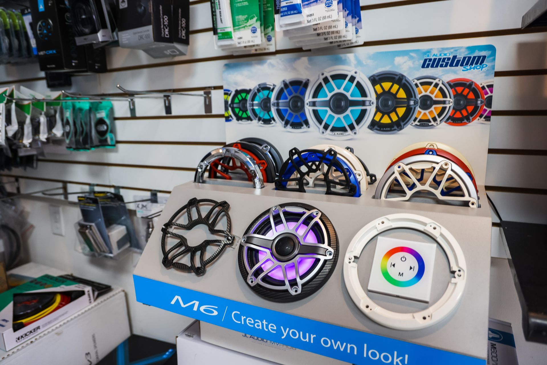 A display of speakers in a store with a sign that says `` create your own look ''.