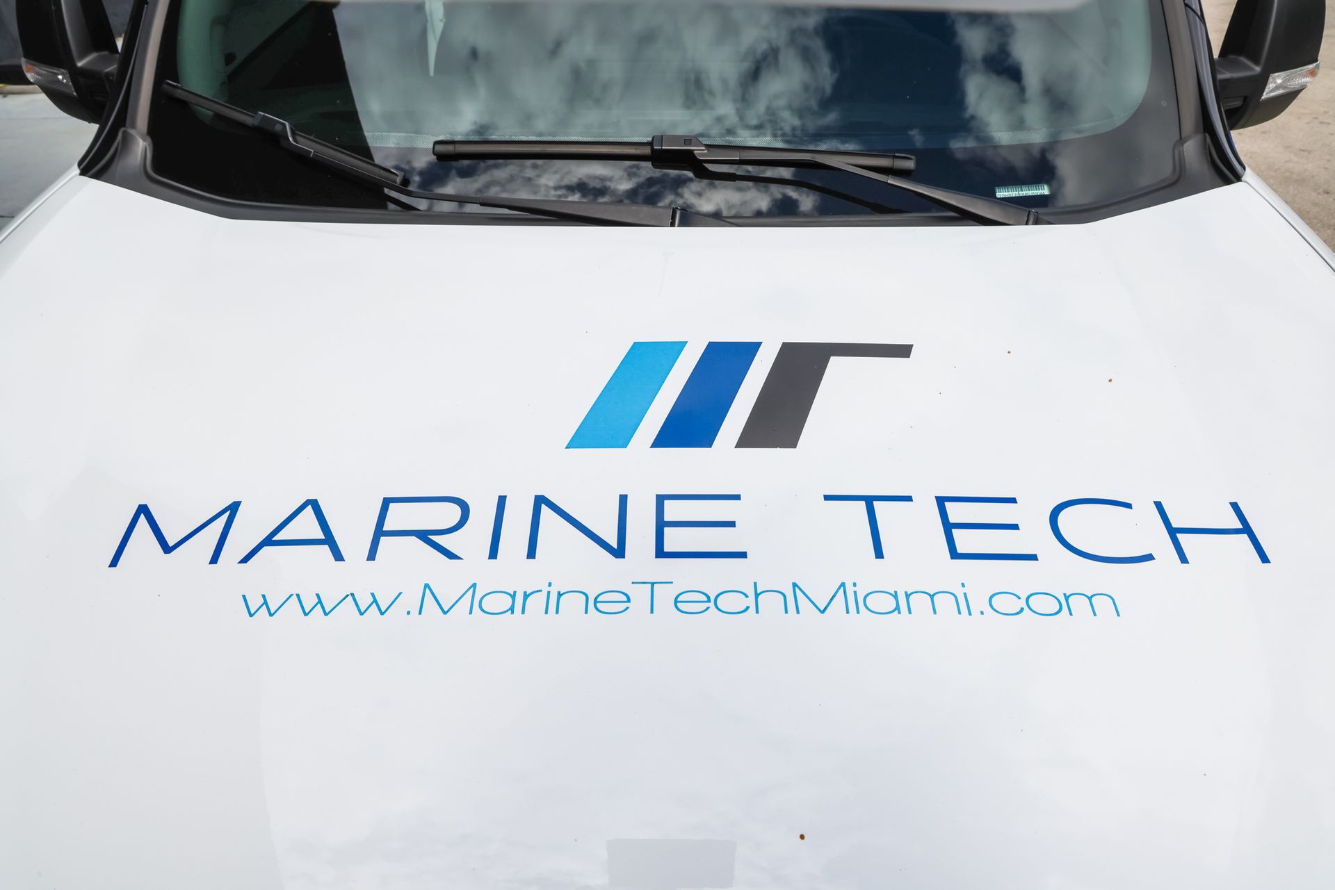 A white car with the word marine tech on the hood