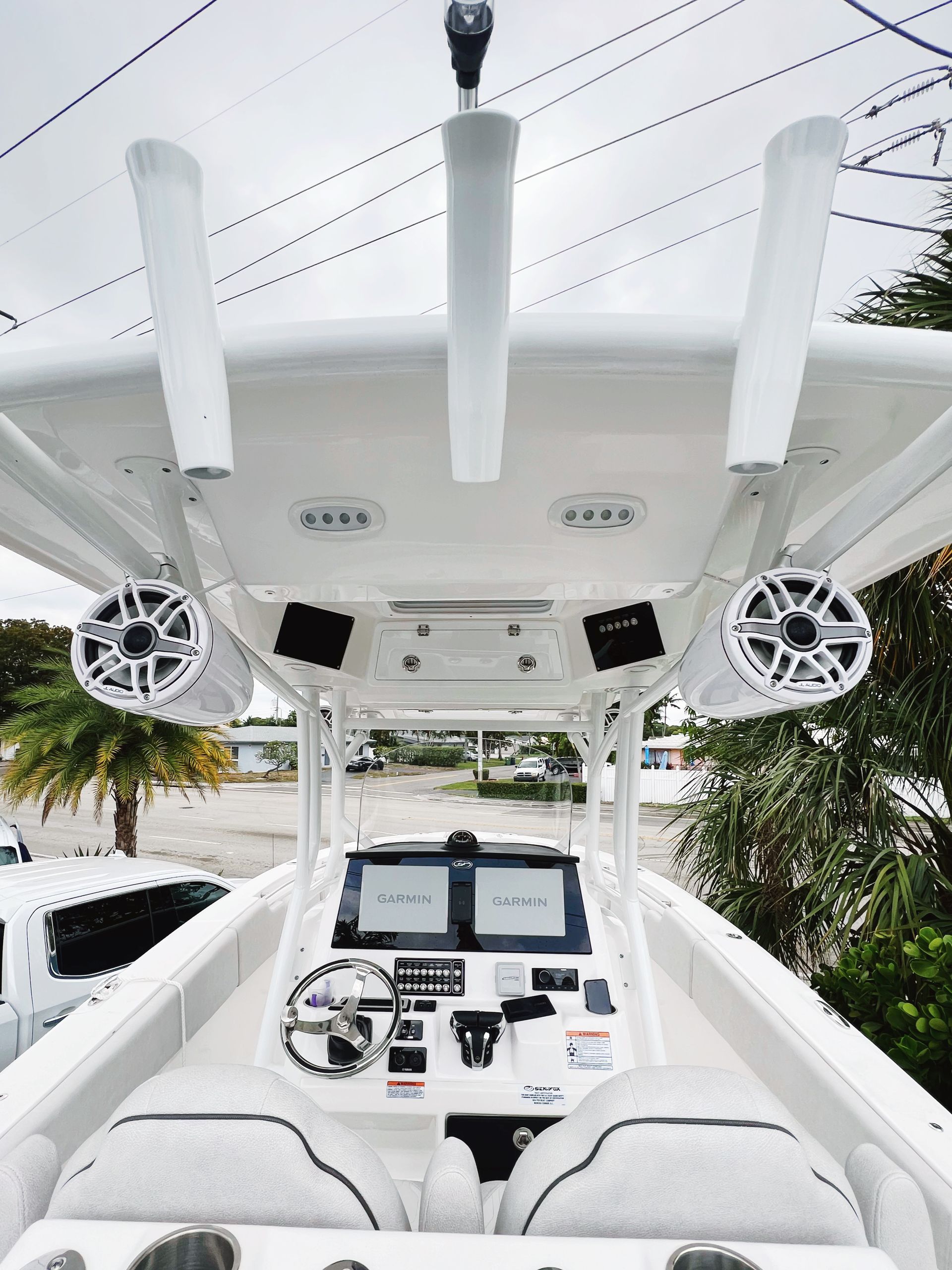 The inside of a white boat with speakers on the ceiling