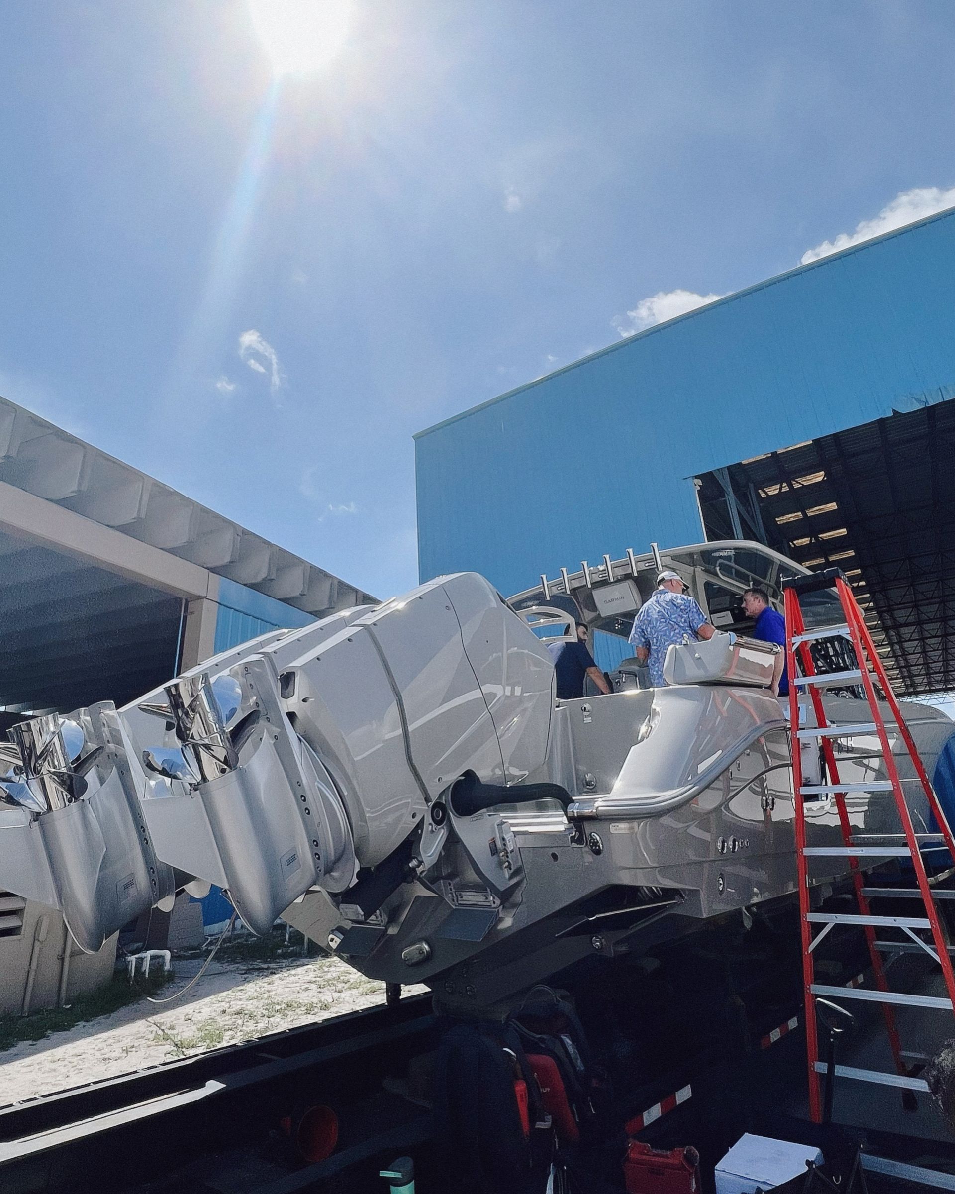 A group of people are working on a boat in a warehouse.