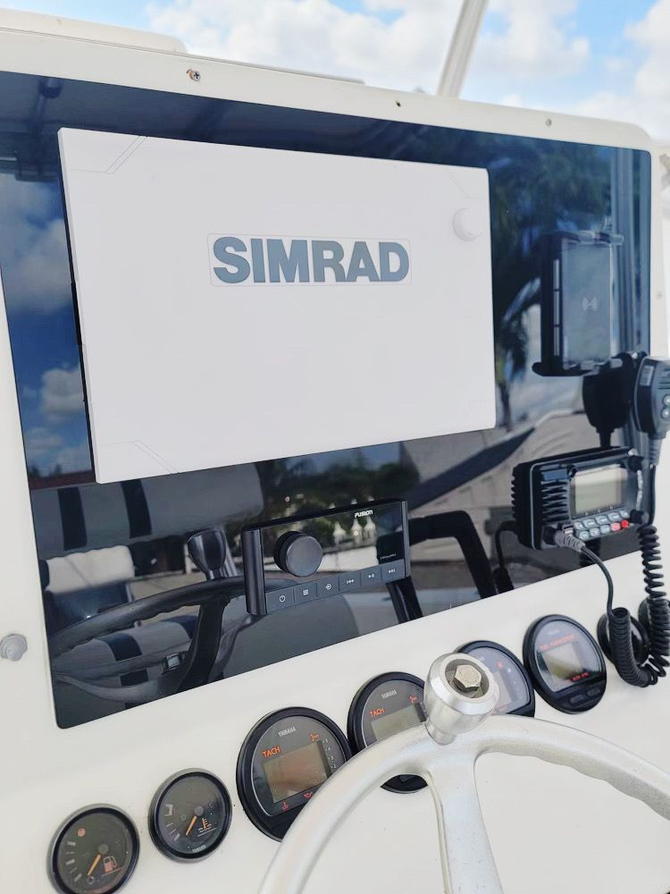 A simrad device is mounted on the side of a boat