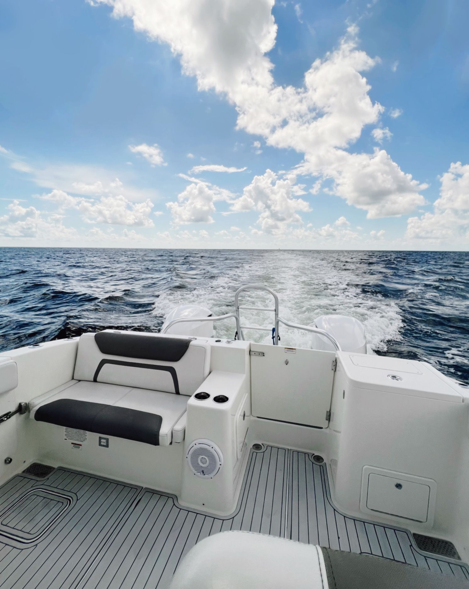 A boat is floating on top of a large body of water.