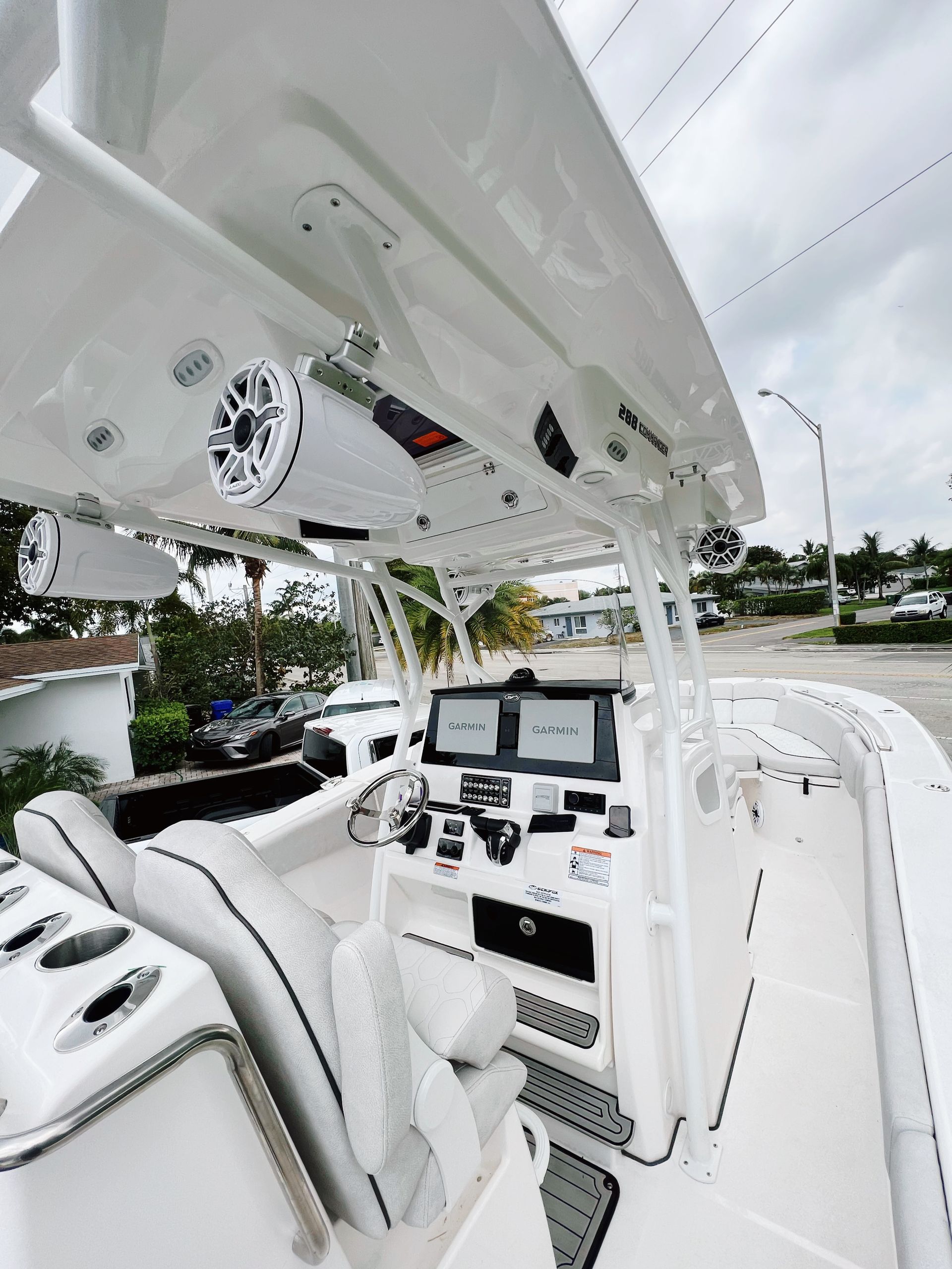 The inside of a white boat with speakers on the ceiling