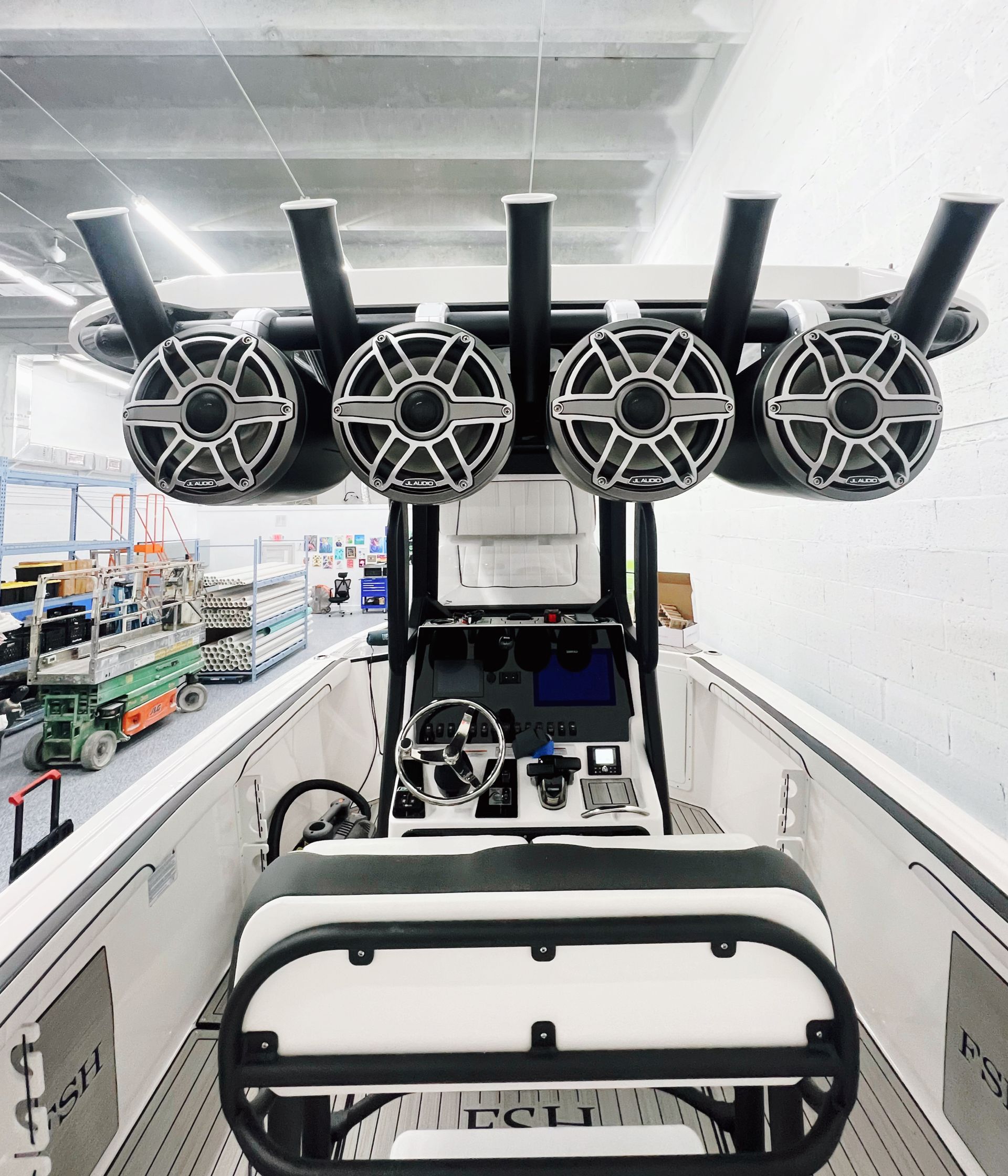 The front of a boat with speakers on top of it.