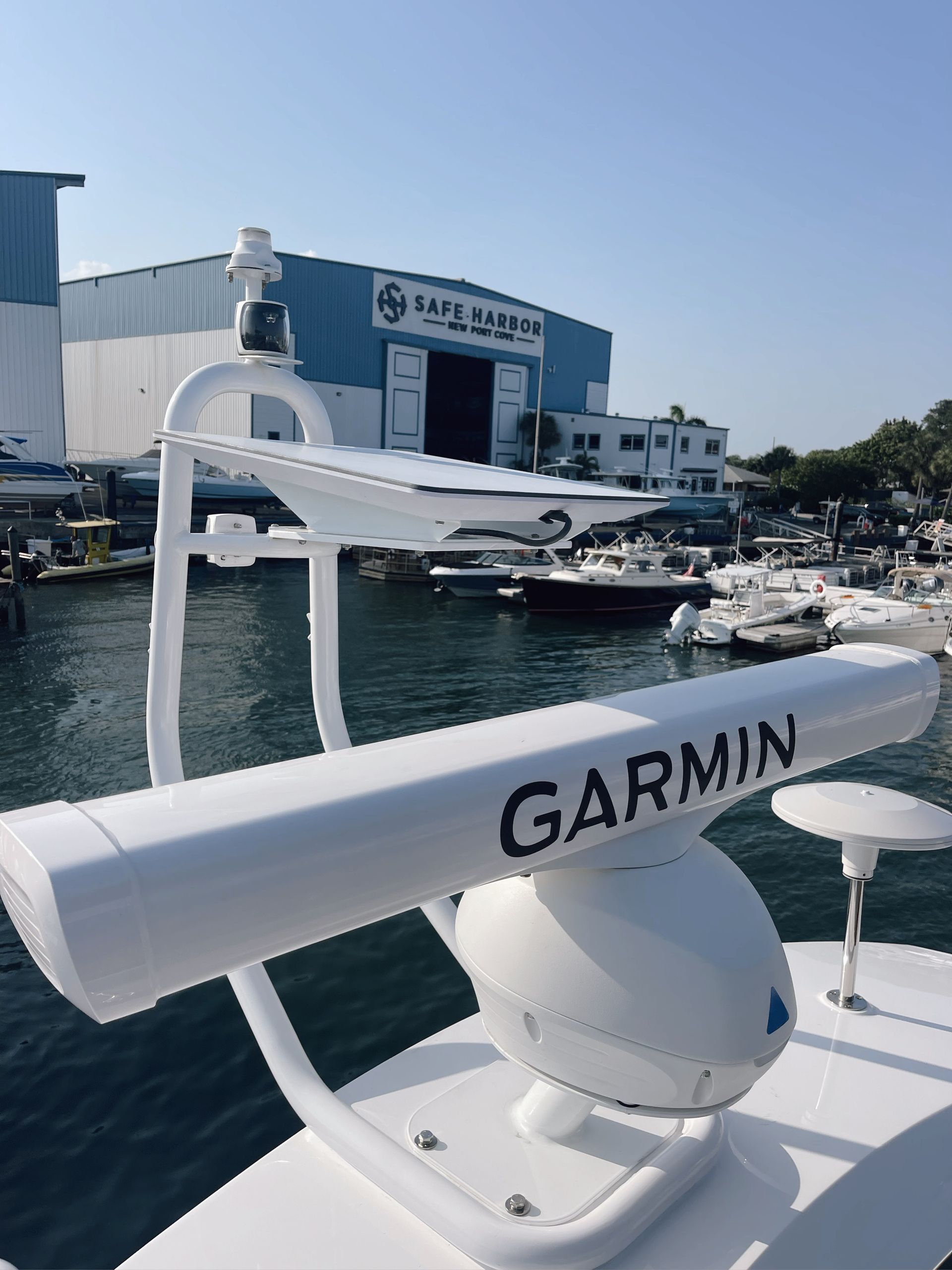 A white garmin radar is on the side of a boat