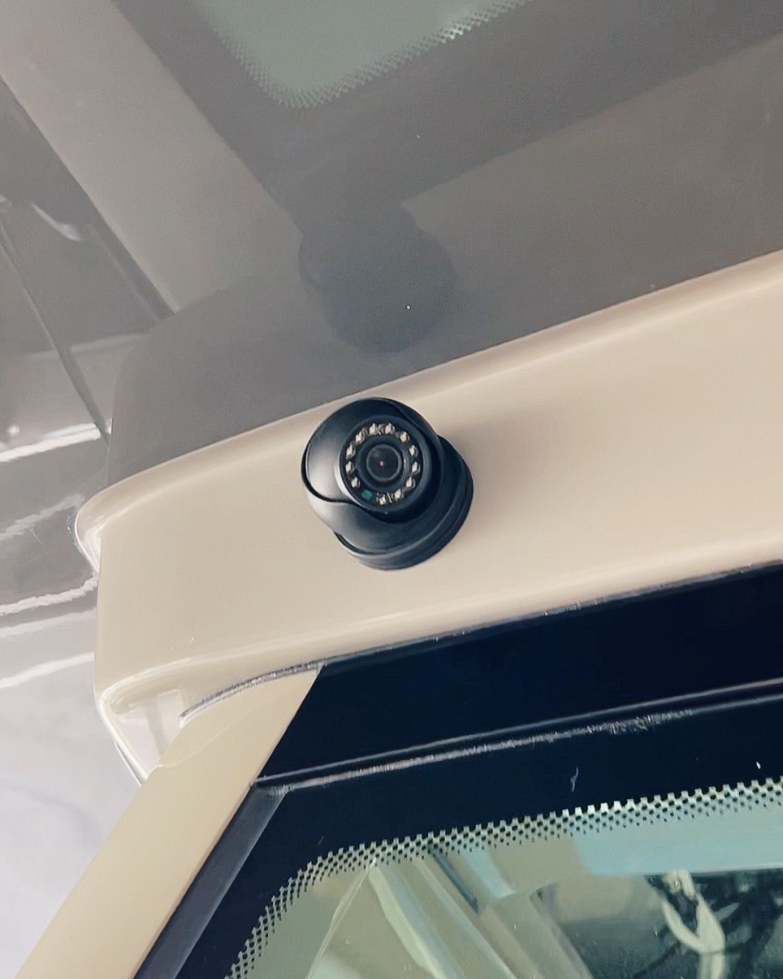 A close up of a camera on the side of a car