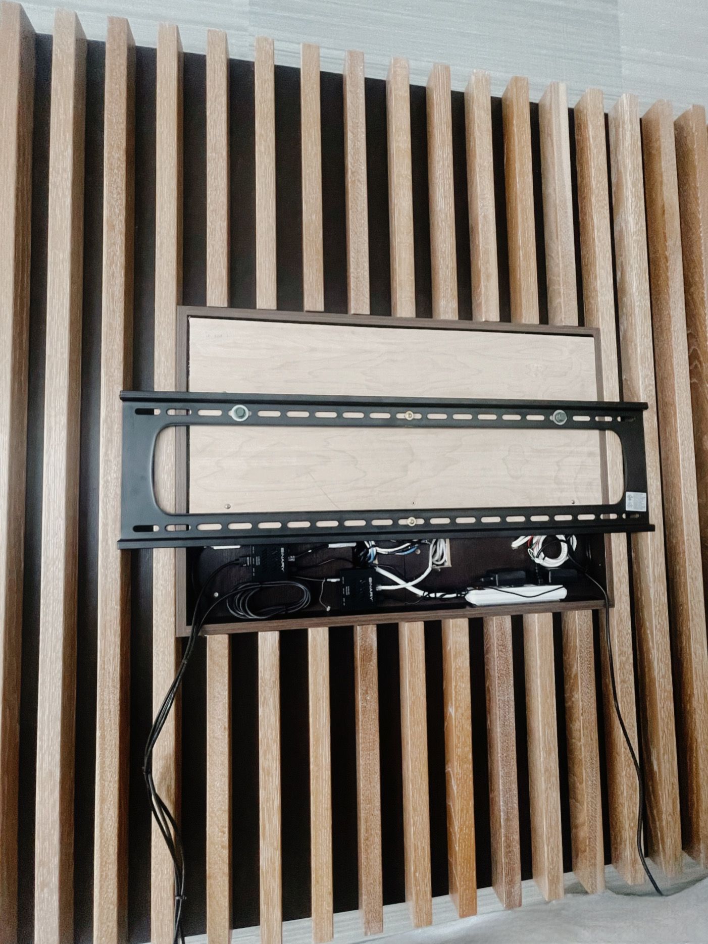 A flat screen tv mounted on a wooden wall