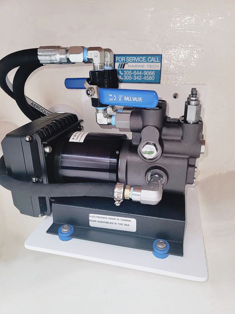 A hydraulic pump is sitting on top of a white table.