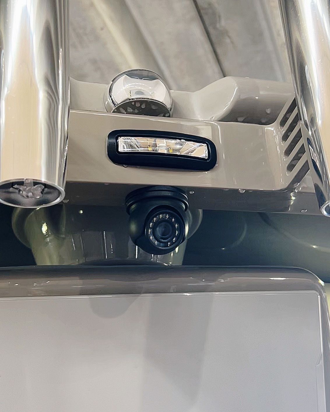 A close up of a camera on the back of a vehicle.