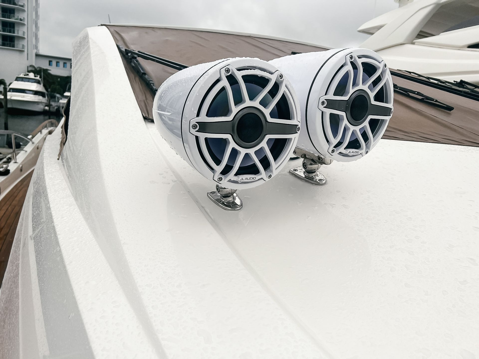 Two speakers are mounted on the roof of a boat