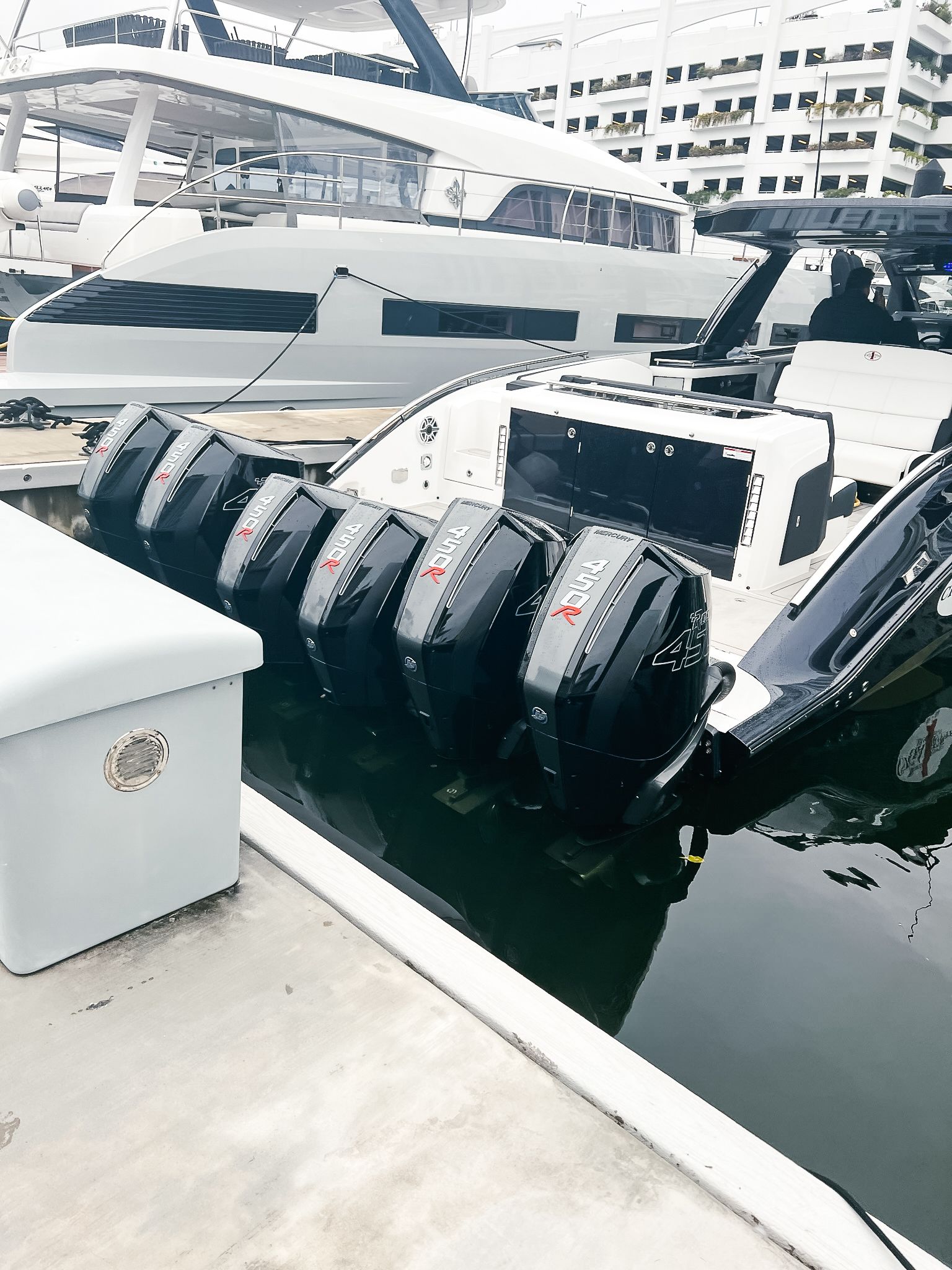 A boat with a lot of engines is docked in a marina