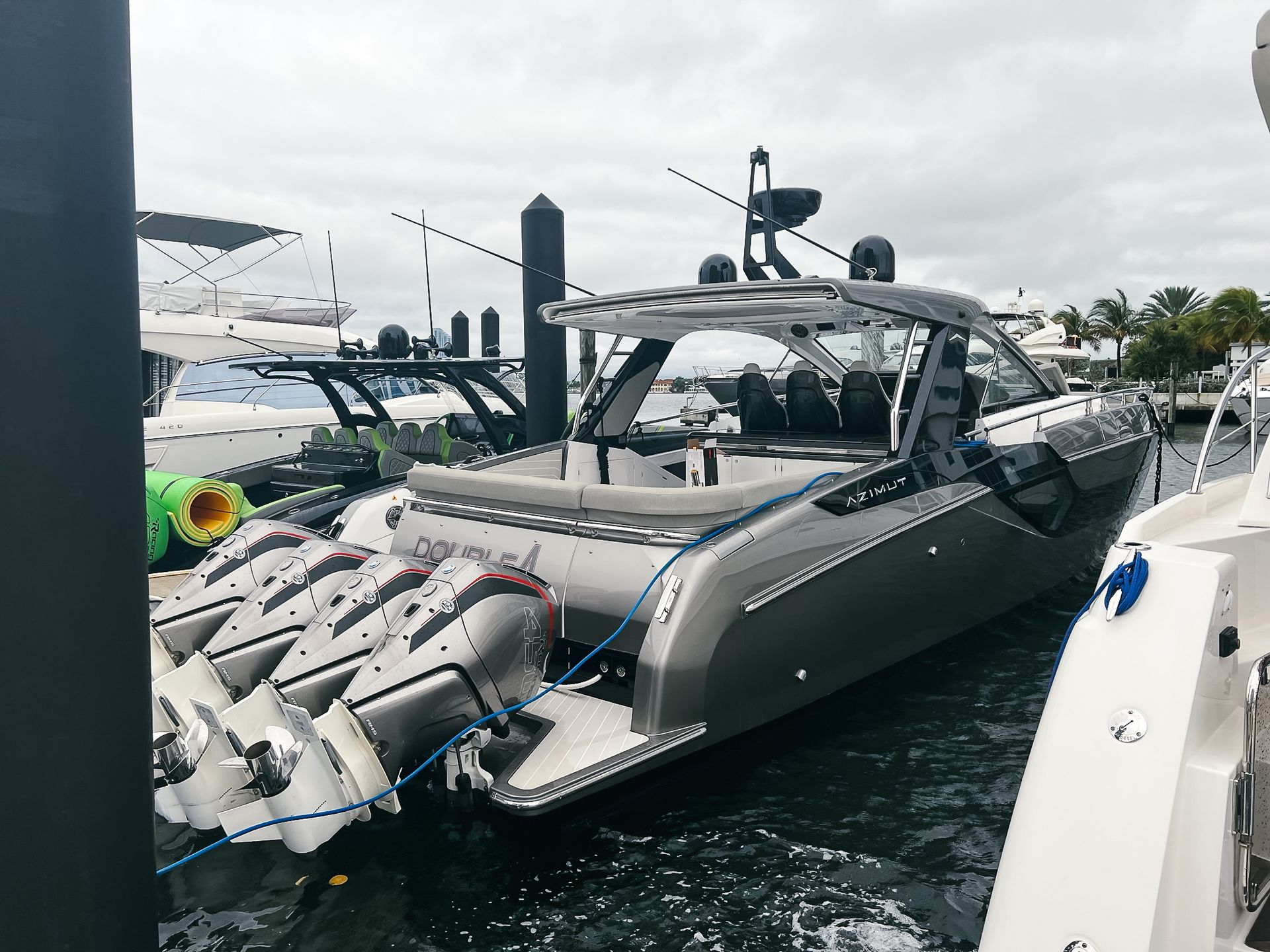 A large boat is docked in a marina next to a dock.