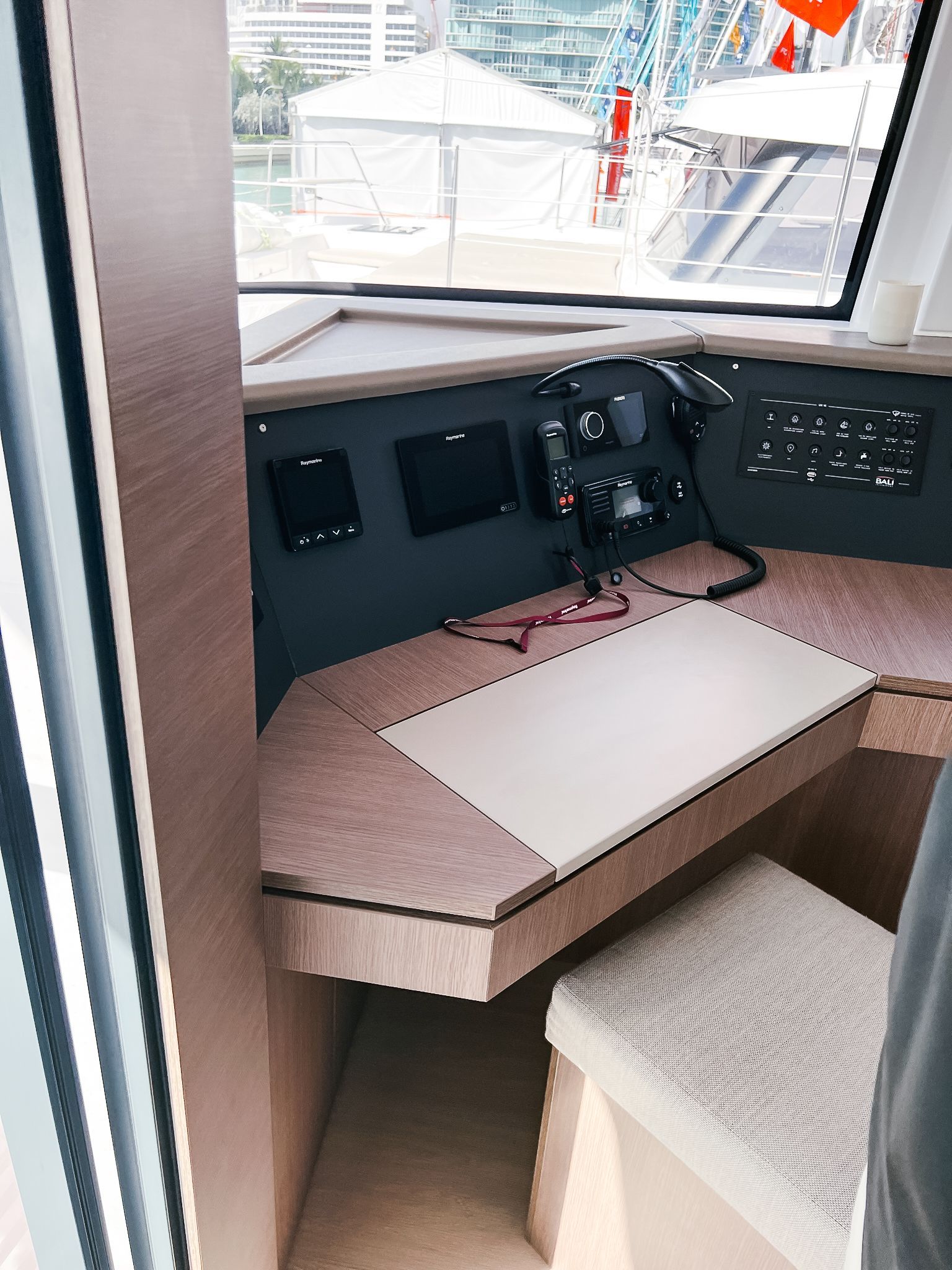 A corner of a room with a desk and a window