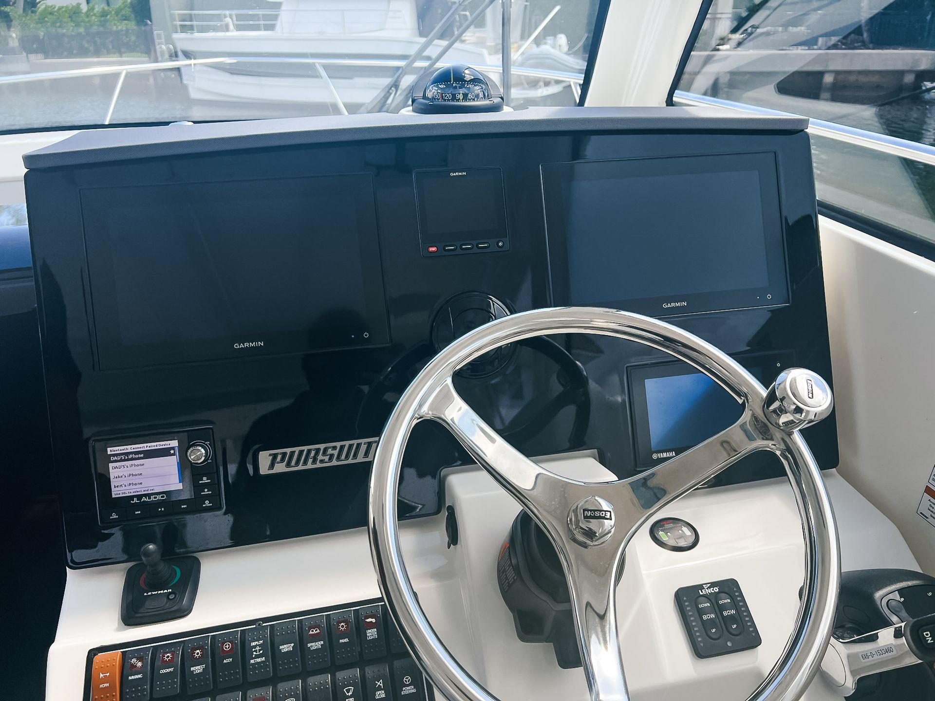 The steering wheel of a boat has the word pineapple on it