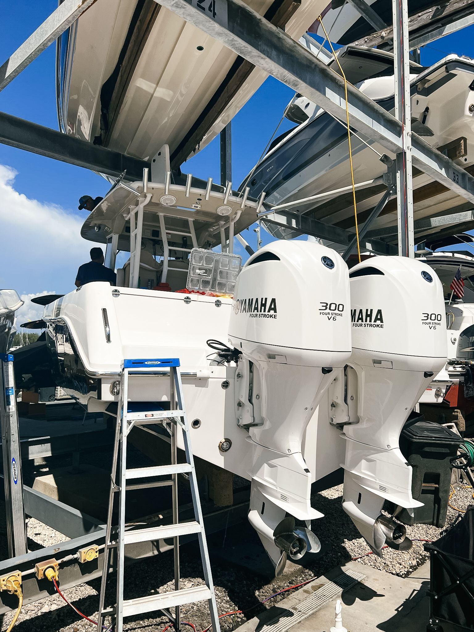 A ladder is sitting on top of a boat in a marina.