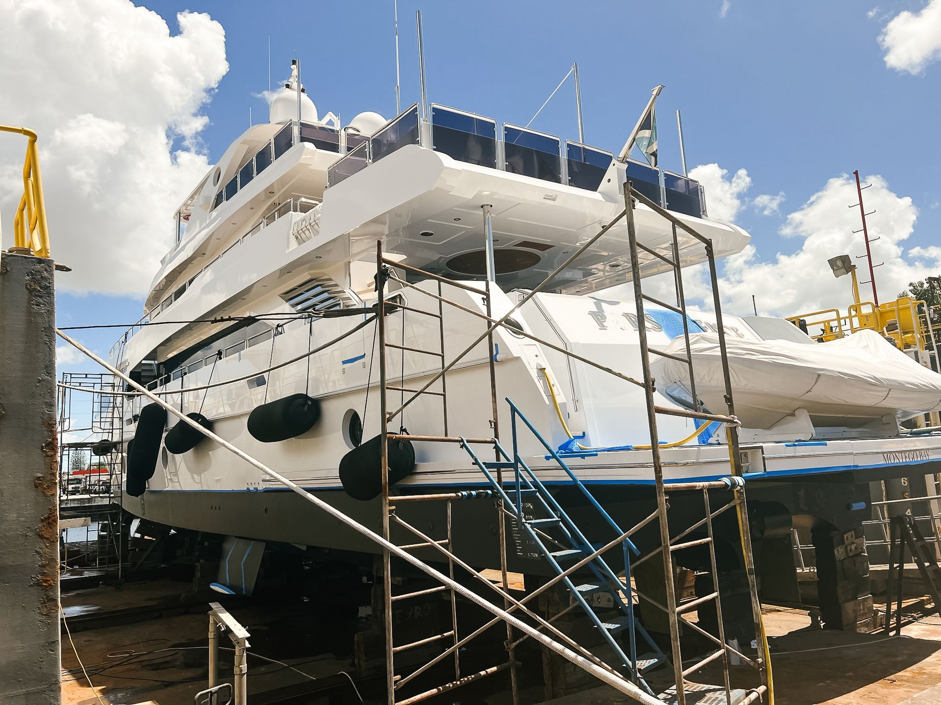 A large white boat is sitting on top of a scaffolding.