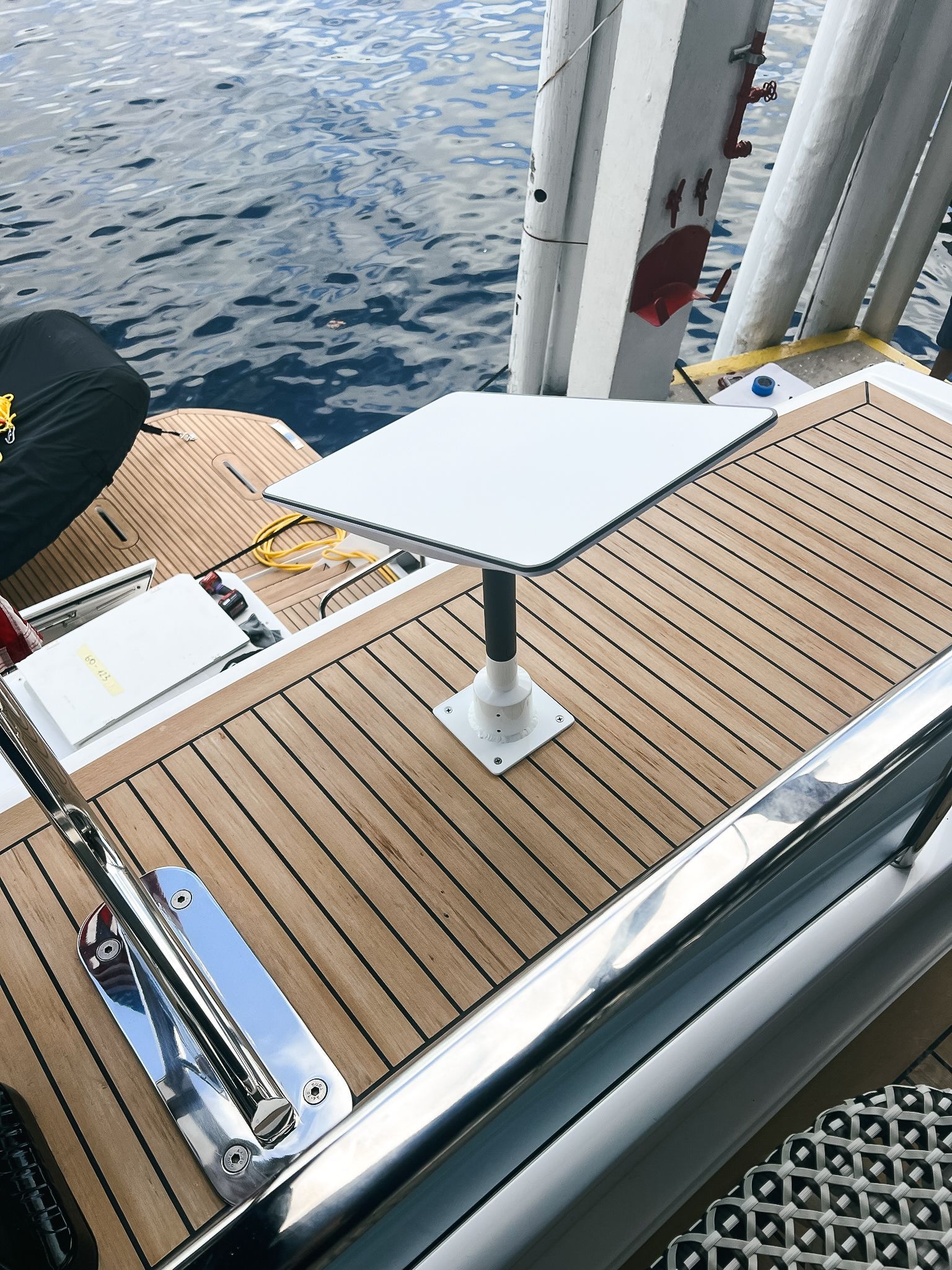 A white table is on the deck of a boat in the water