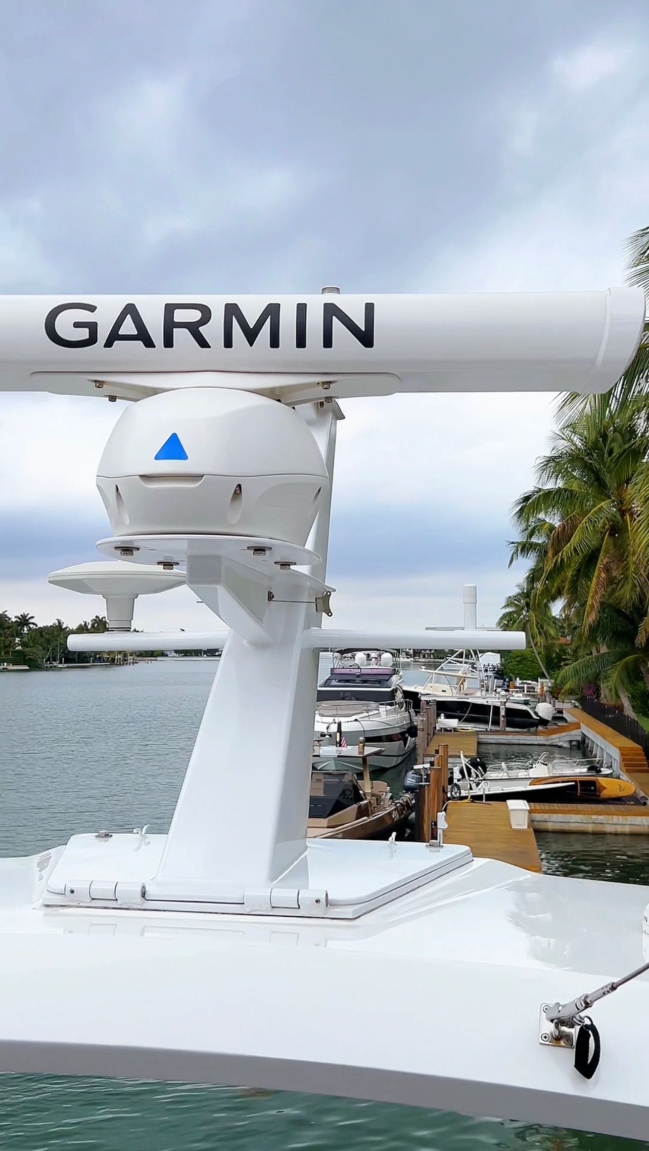 A garmin radar is mounted on the side of a boat.