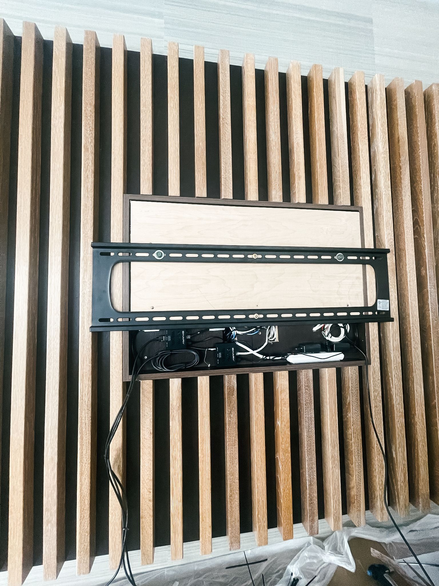 A flat screen tv mounted on a wooden wall