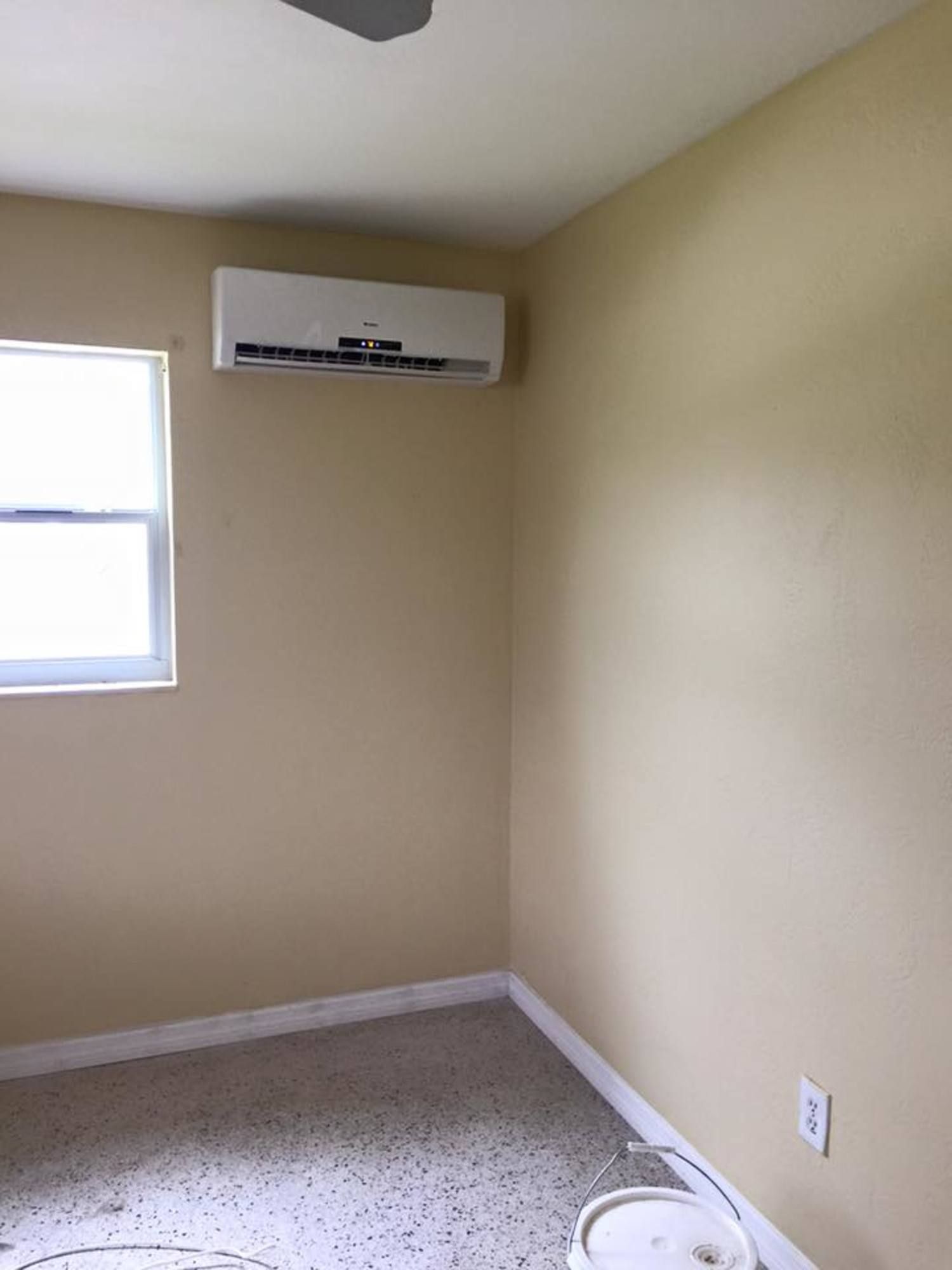 There is a ceiling fan in the corner of the room.