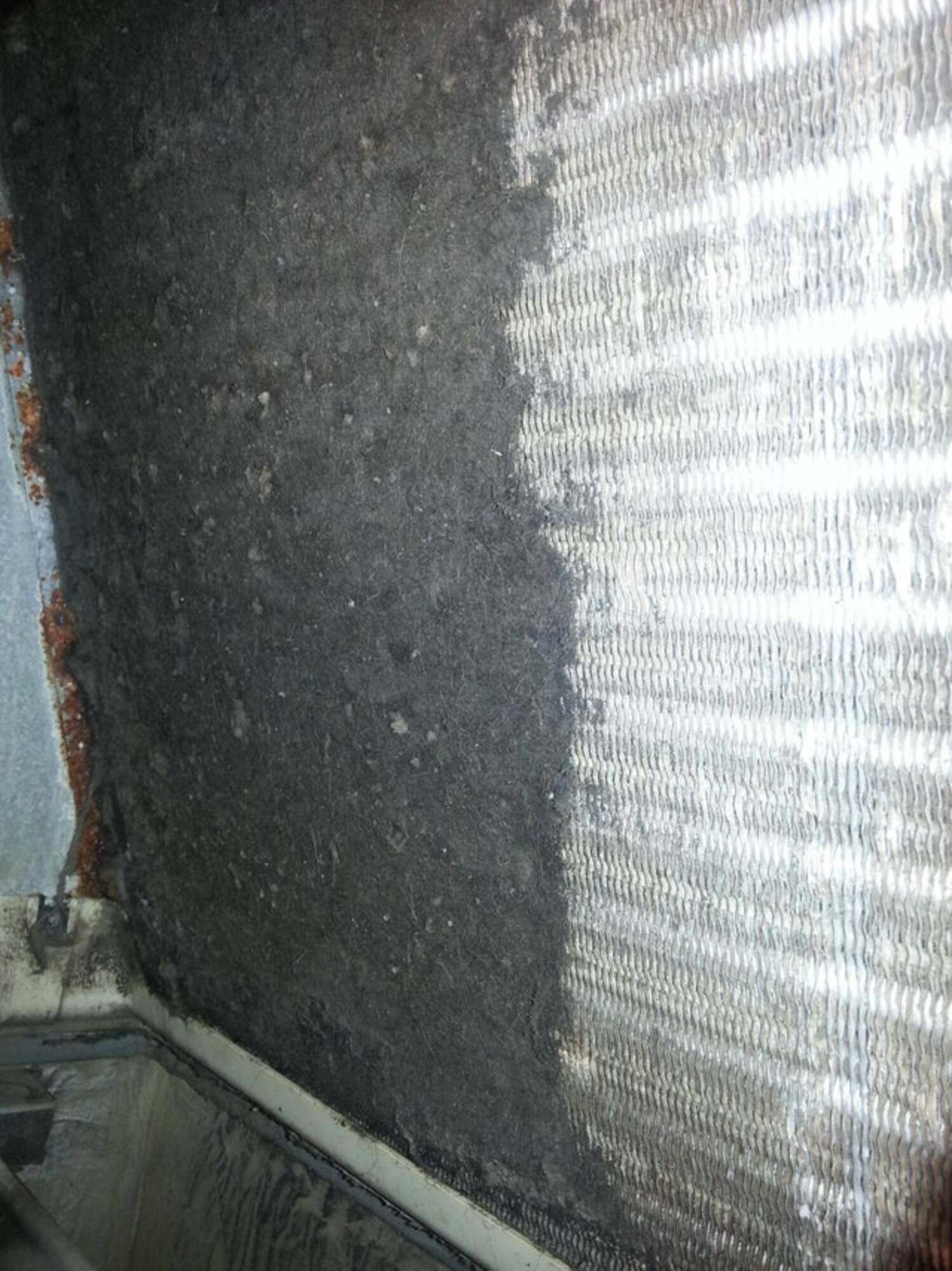 A close up of a dirty radiator with a lot of dust on it.