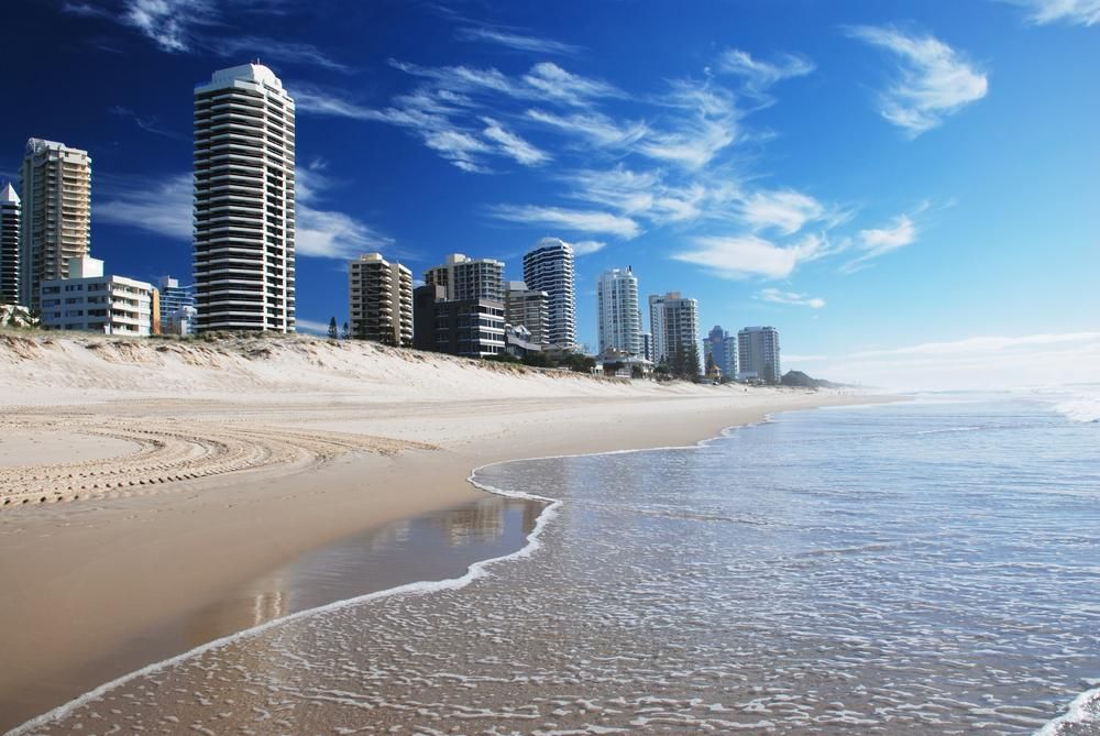 A Beach with Tall Buildings in The Background and A City in The Distance — Barry's Recycling in Redland Bay, QLD