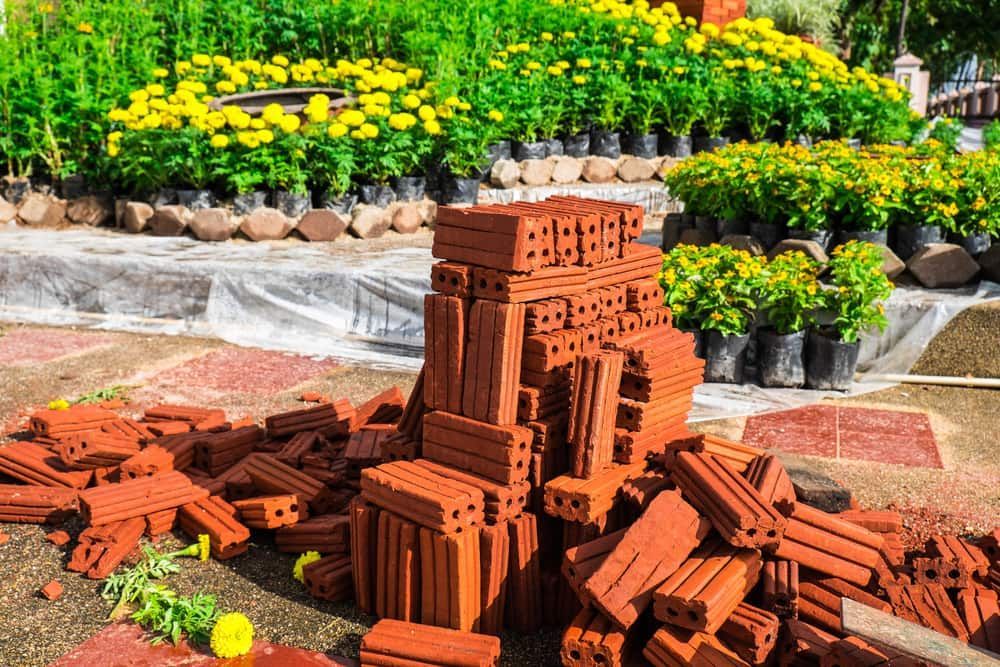 A Pile of Bricks Is Sitting on The Ground in Front of A Garden — Barry's Recycling in Redland Bay, QLD