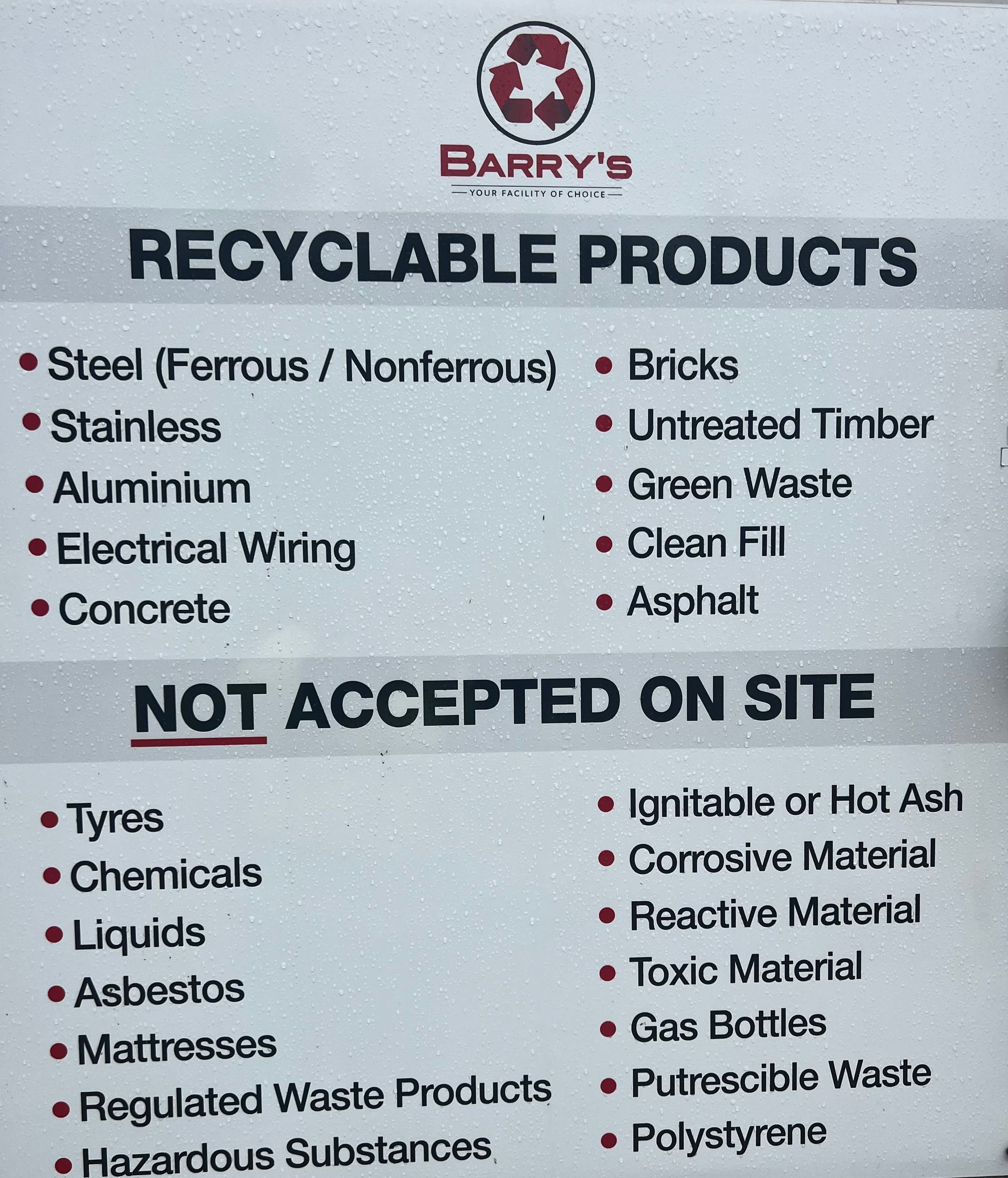 A Large Orange Excavator Is Loading a Dump Truck on A Construction Site — Barry's Recycling in Redland Bay, QLD