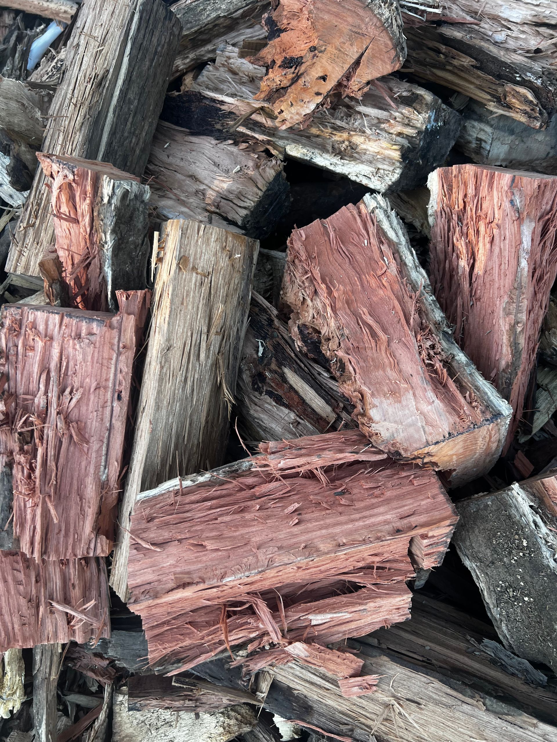 A Pile of Bricks Is Sitting on The Ground in Front of A Garden — Barry's Recycling in Redland Bay, QLD