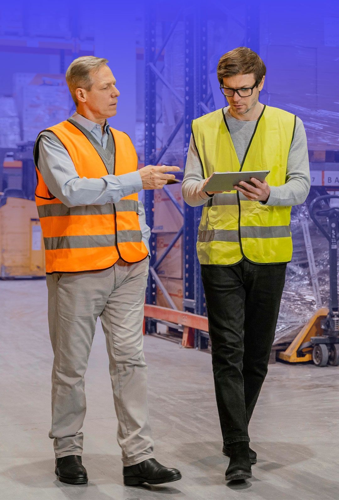 Construction site with blueprints and safety helmets on table