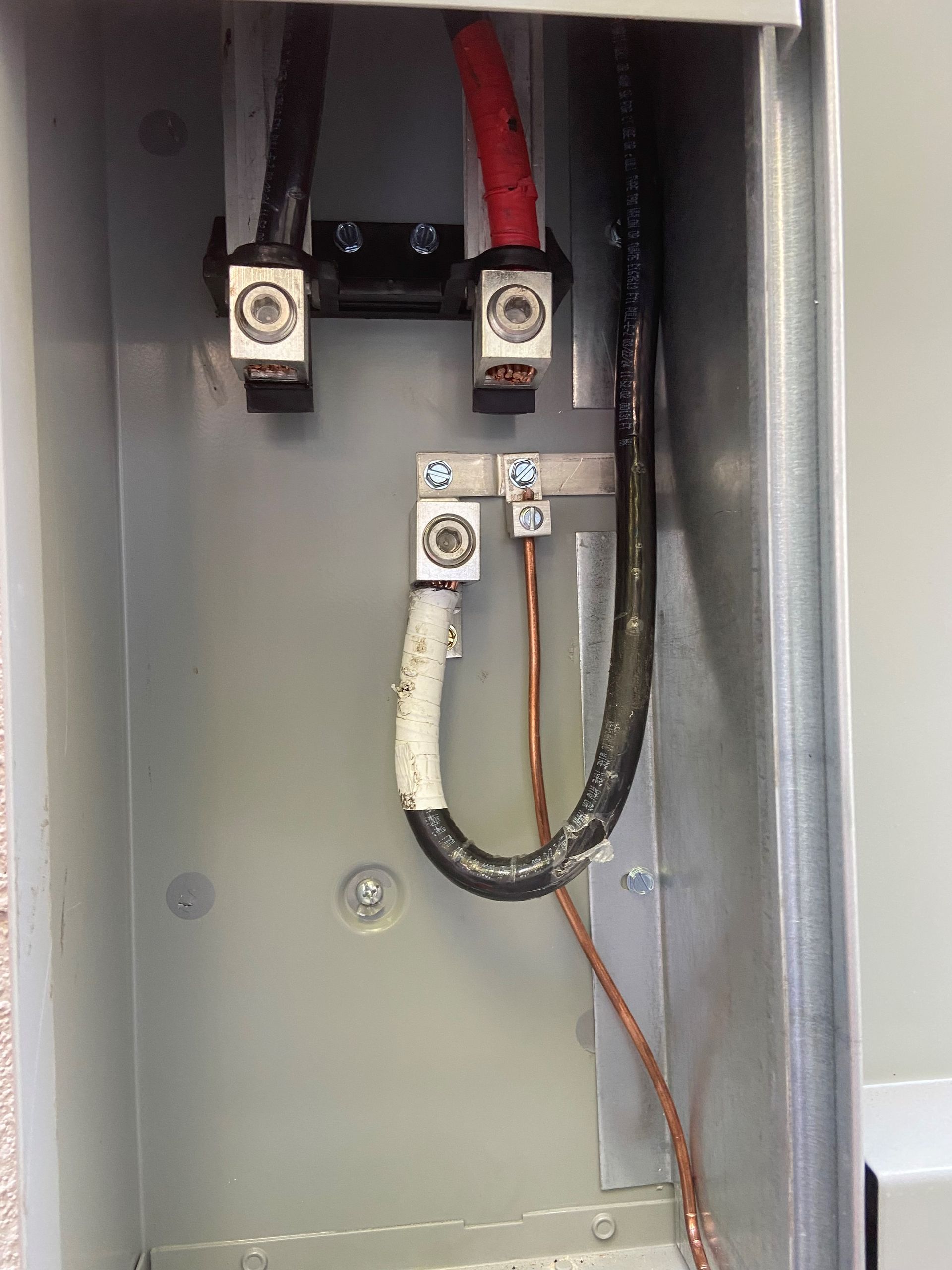 A close up of a electrical box with wires coming out of it.