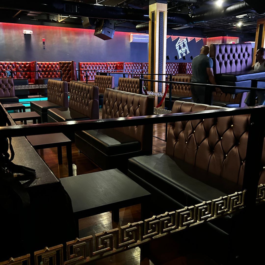 A greek key design is on a railing in a restaurant