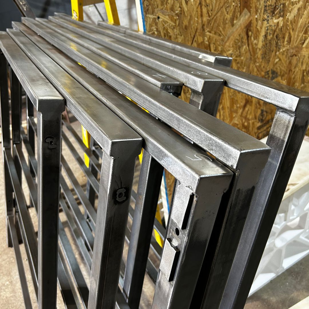 A stack of metal bars sitting on top of each other on a table.